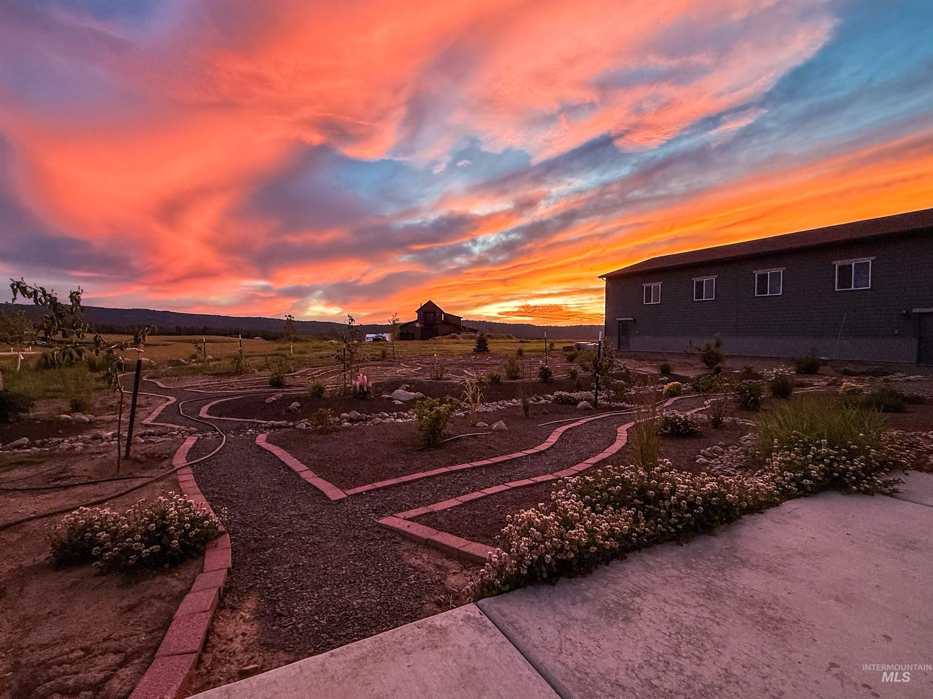 Landscaped grounds featuring gravel pathways bordered by brick edging