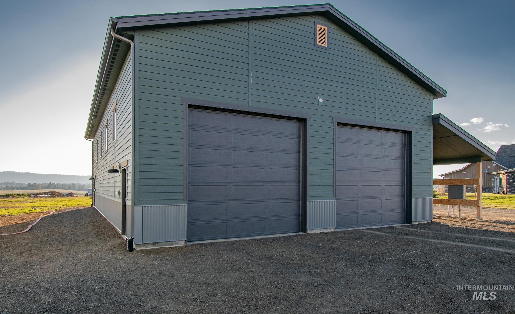Two-bay garage building with horizontal siding and a gambrel roofline