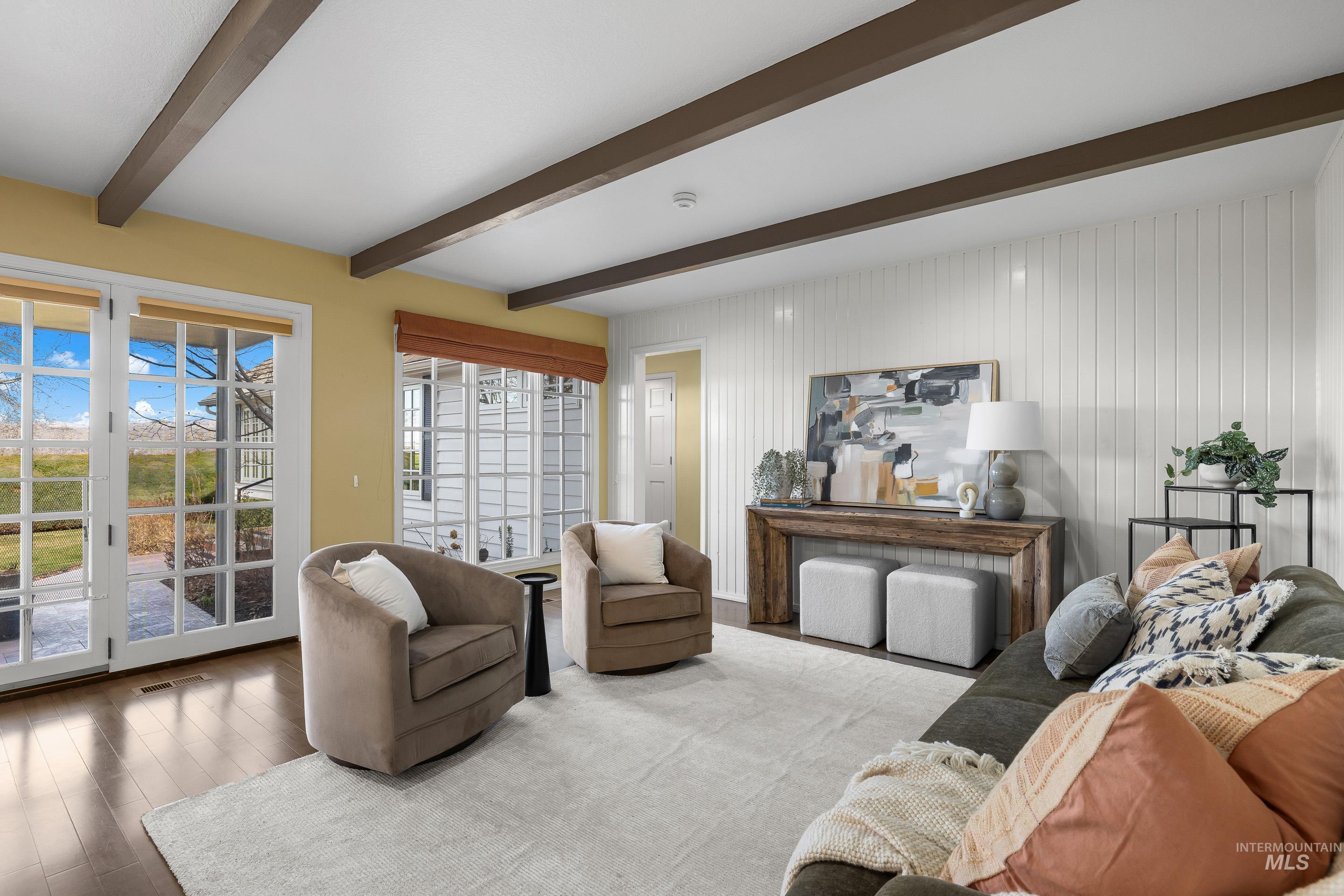 Living room featuring wood finished floors and beamed ceiling