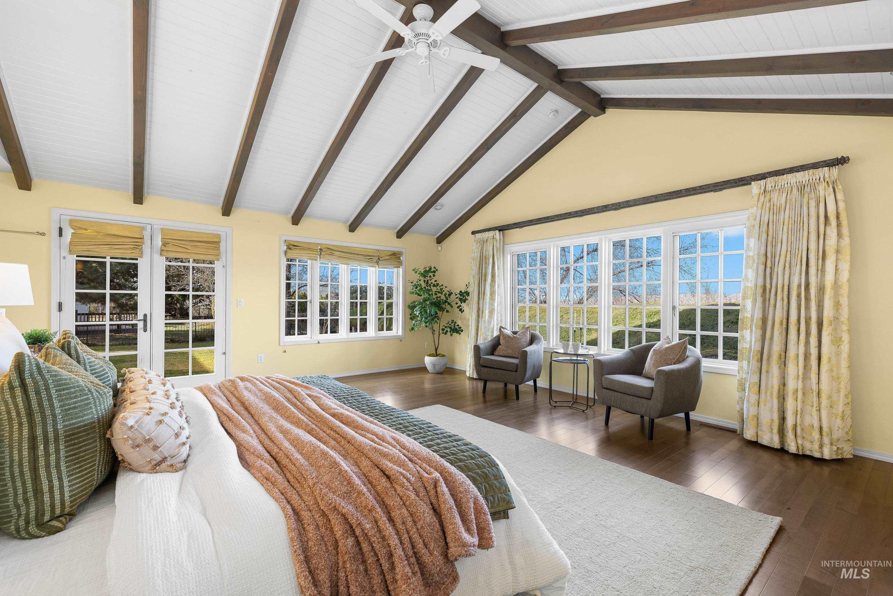Bedroom featuring access to exterior, dark wood-style flooring, beamed ceiling, and a ceiling fan
