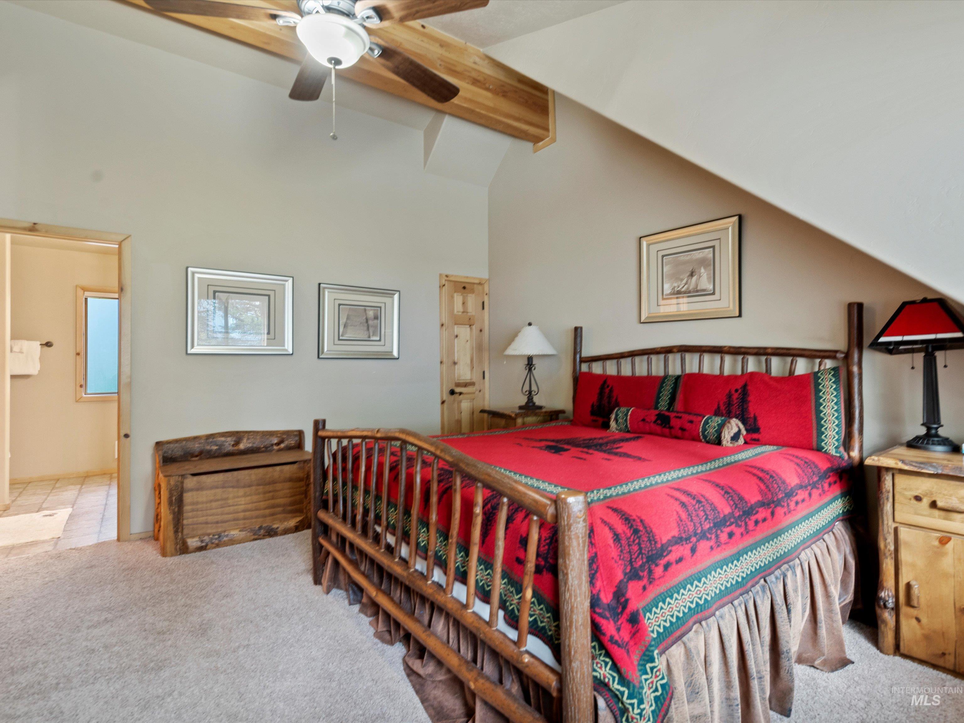 Bedroom with beam ceiling, carpet floors, a ceiling fan, and high vaulted ceiling