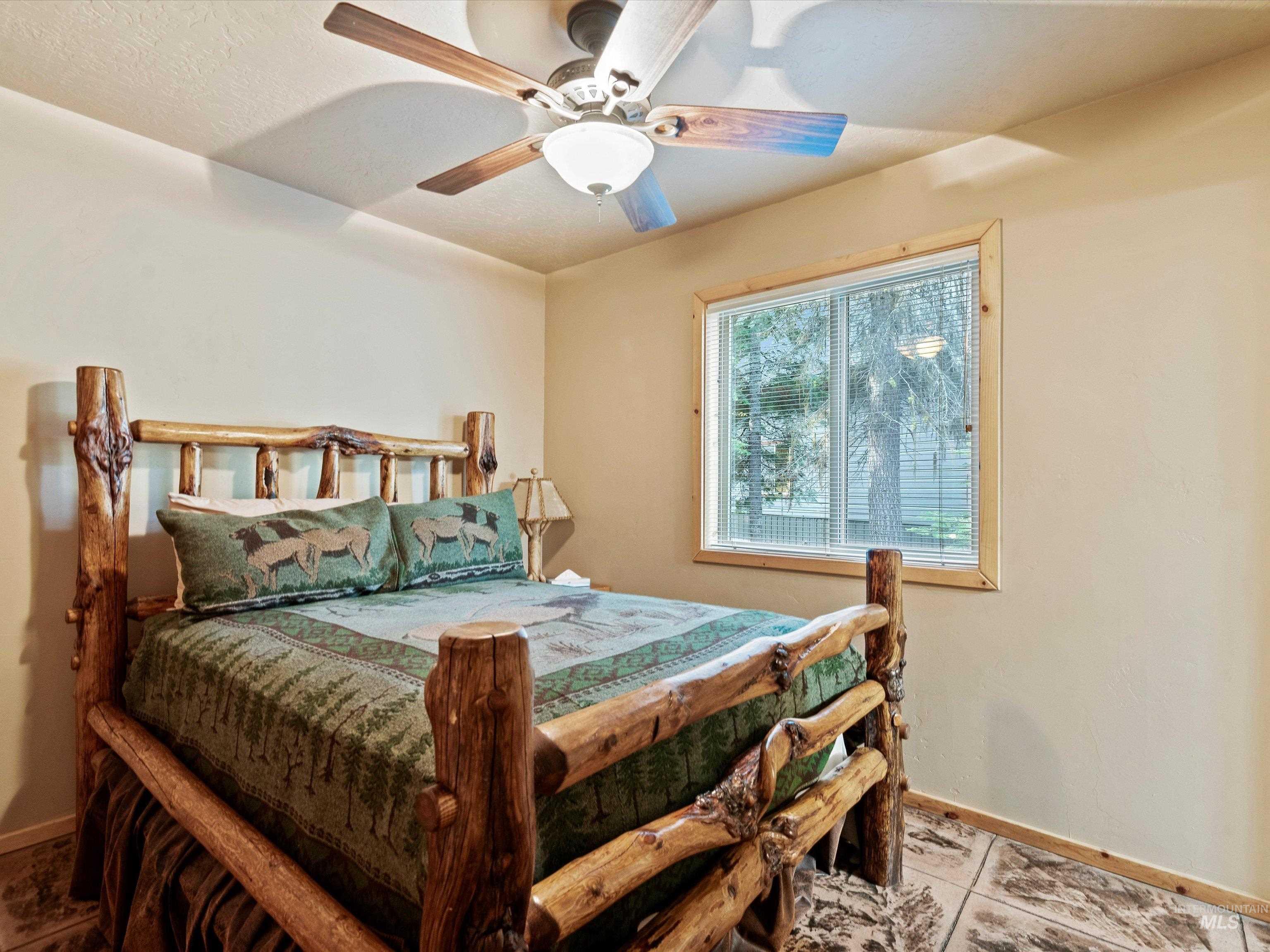 Bedroom featuring tile patterned floors and ceiling fan