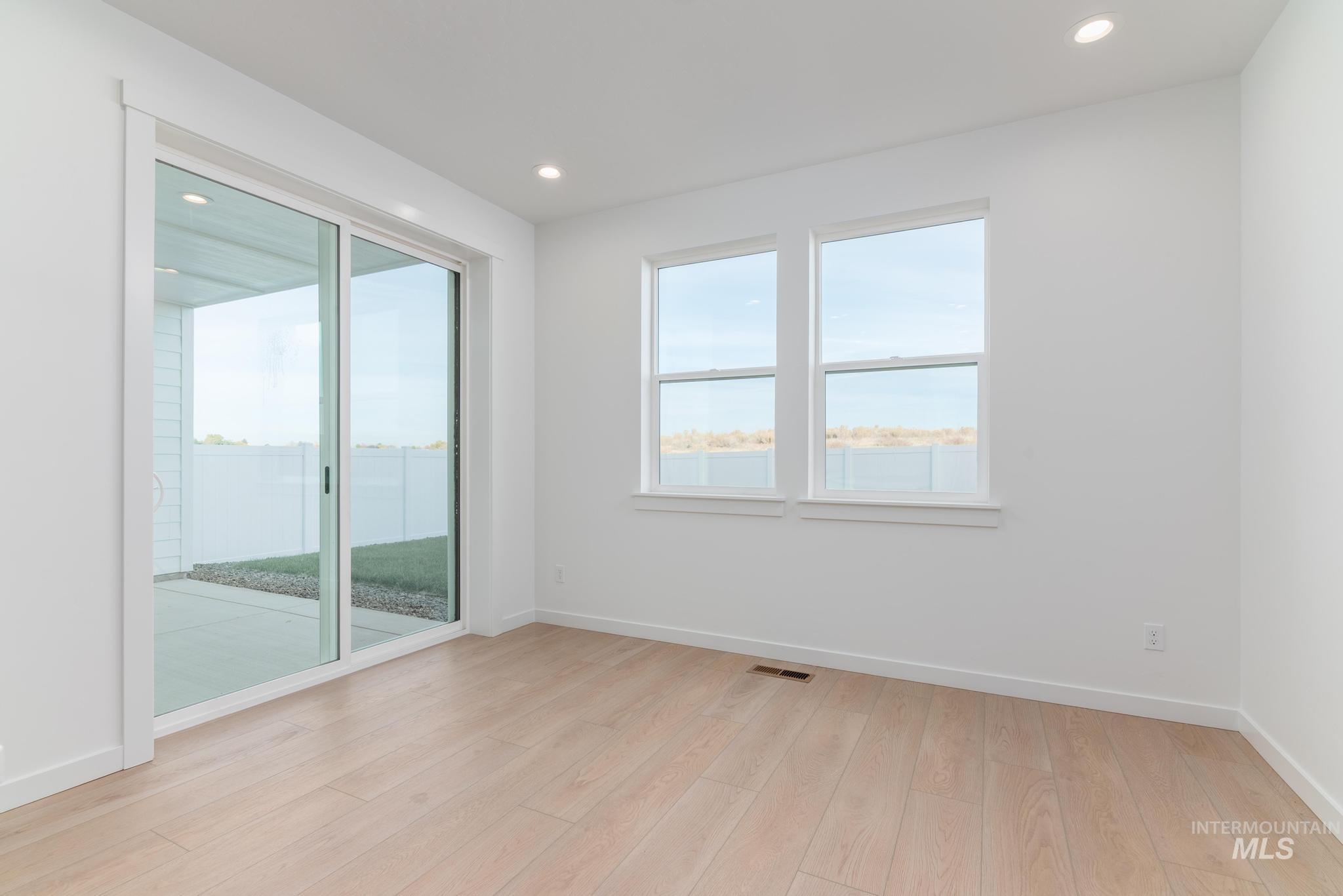 Unfurnished room with light wood-style flooring and recessed lighting