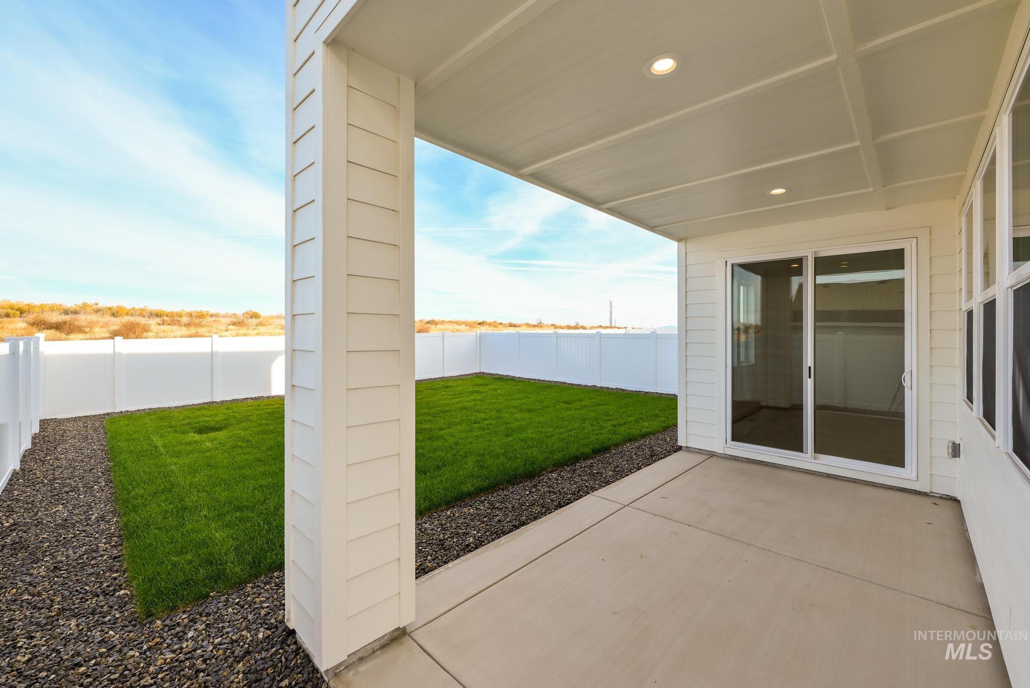Fenced backyard featuring a patio