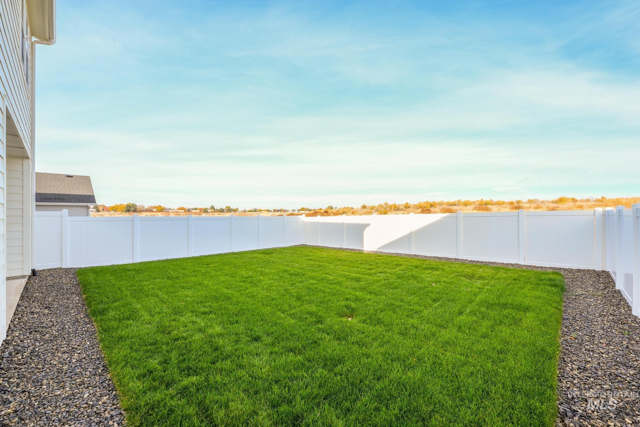 View of fenced backyard