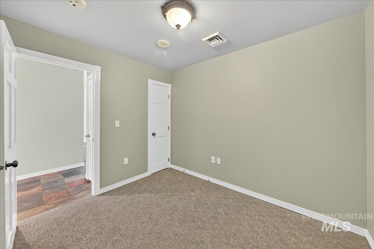 Unfurnished bedroom with baseboards and carpet flooring