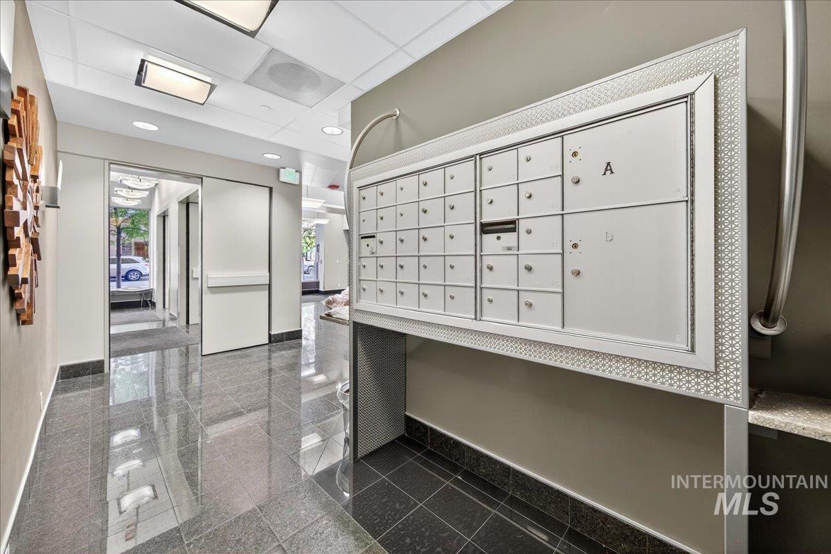 View of property's community featuring a paneled ceiling and mail area