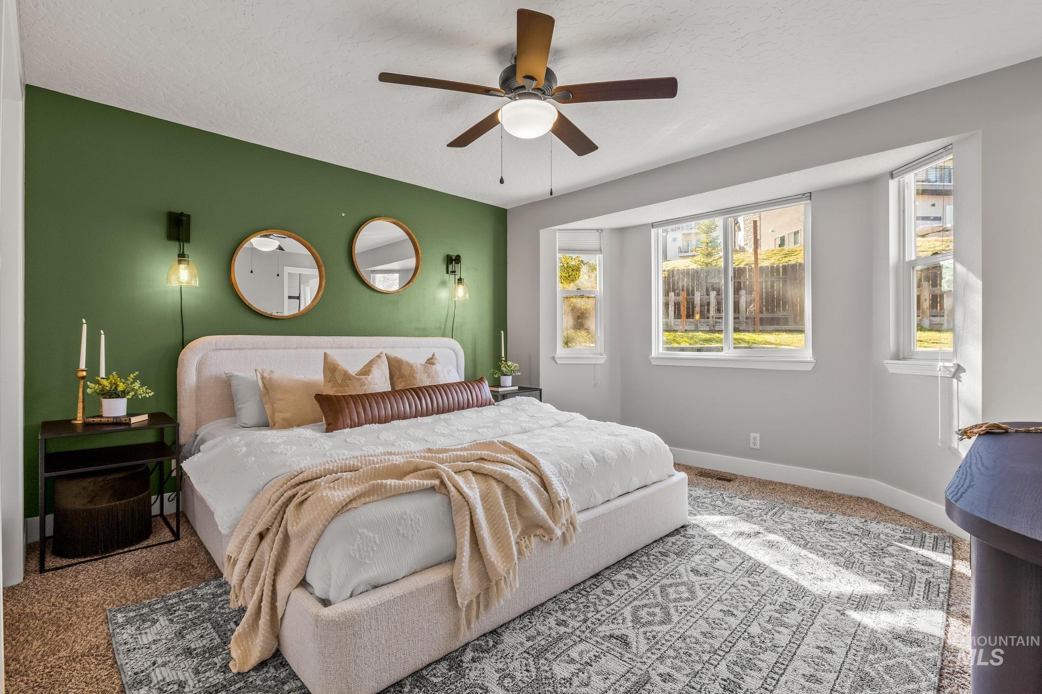 Bedroom featuring carpet flooring, a ceiling fan, and a textured ceiling