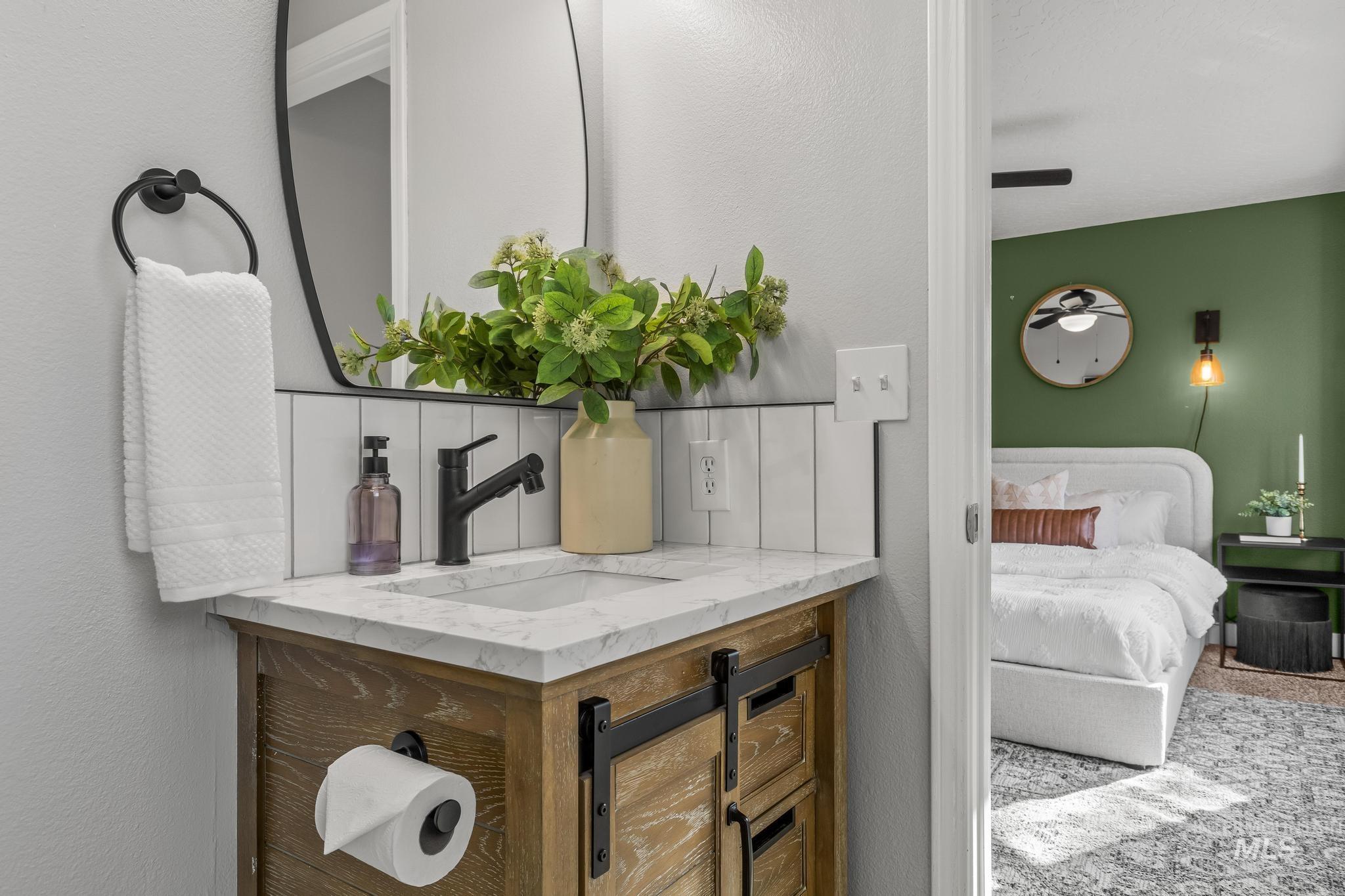 Ensuite bathroom with a textured wall and vanity