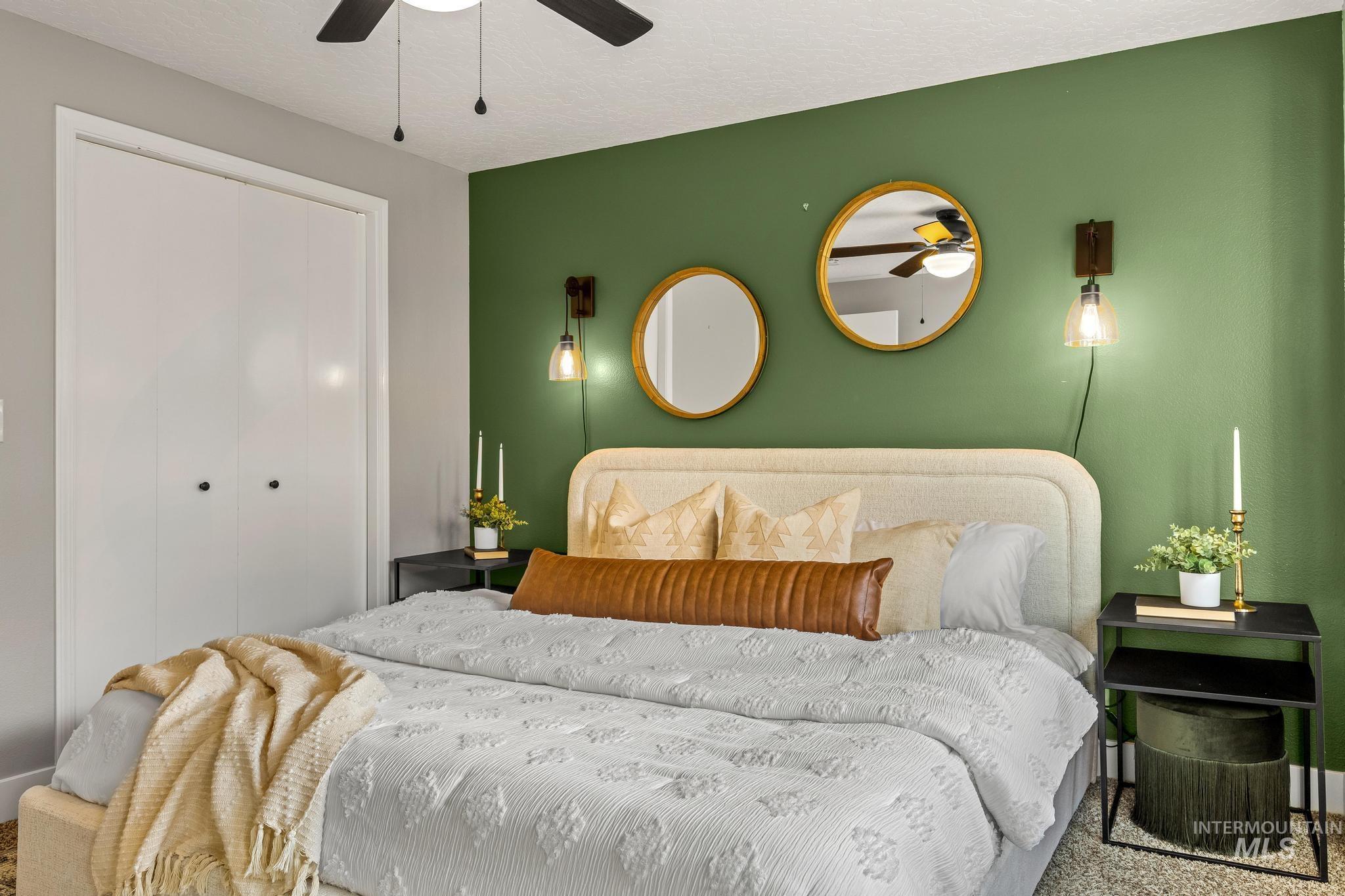 Bedroom with a closet, a textured ceiling, and a ceiling fan