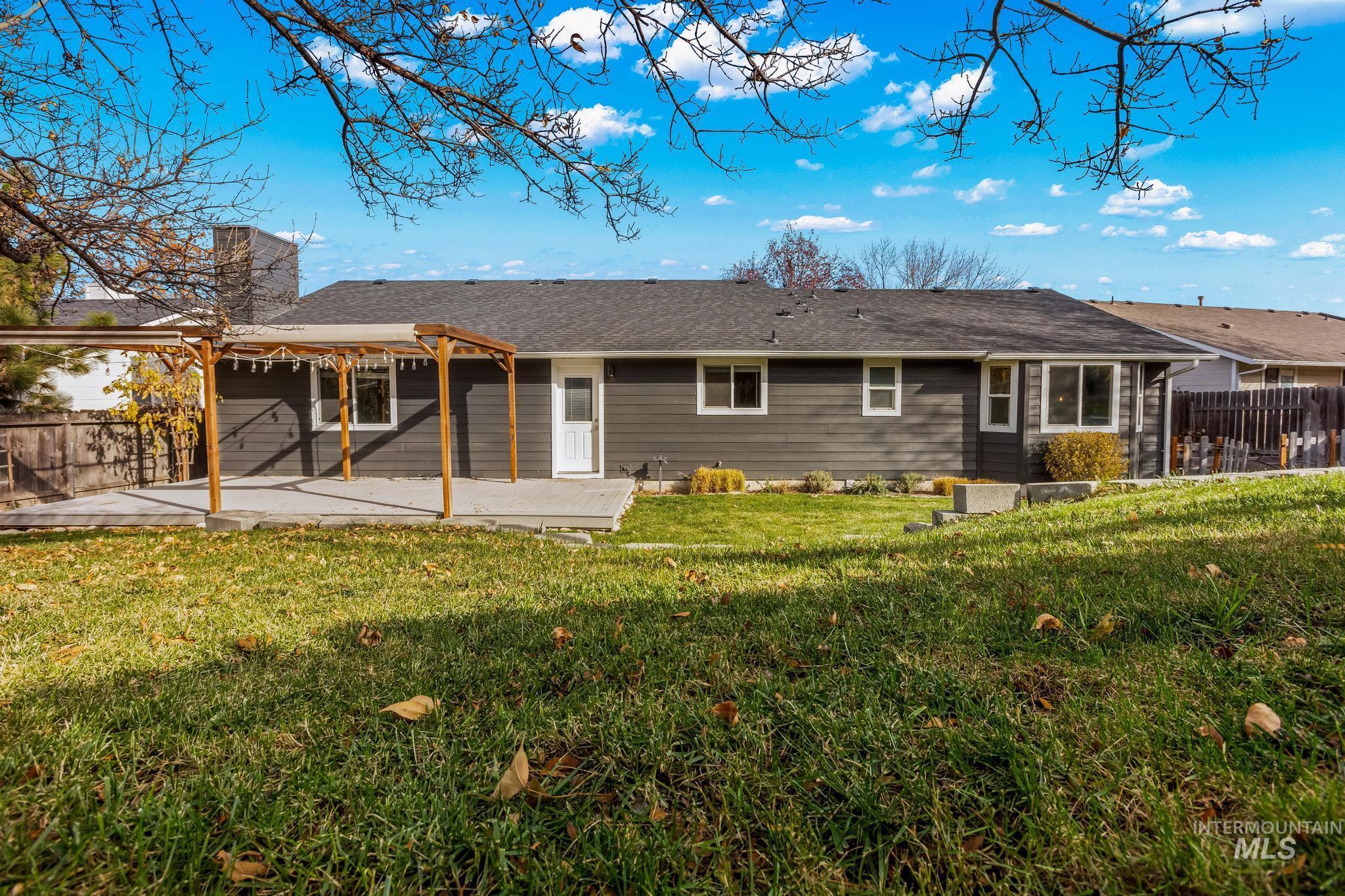 Rear view of house with a chimney and a patio