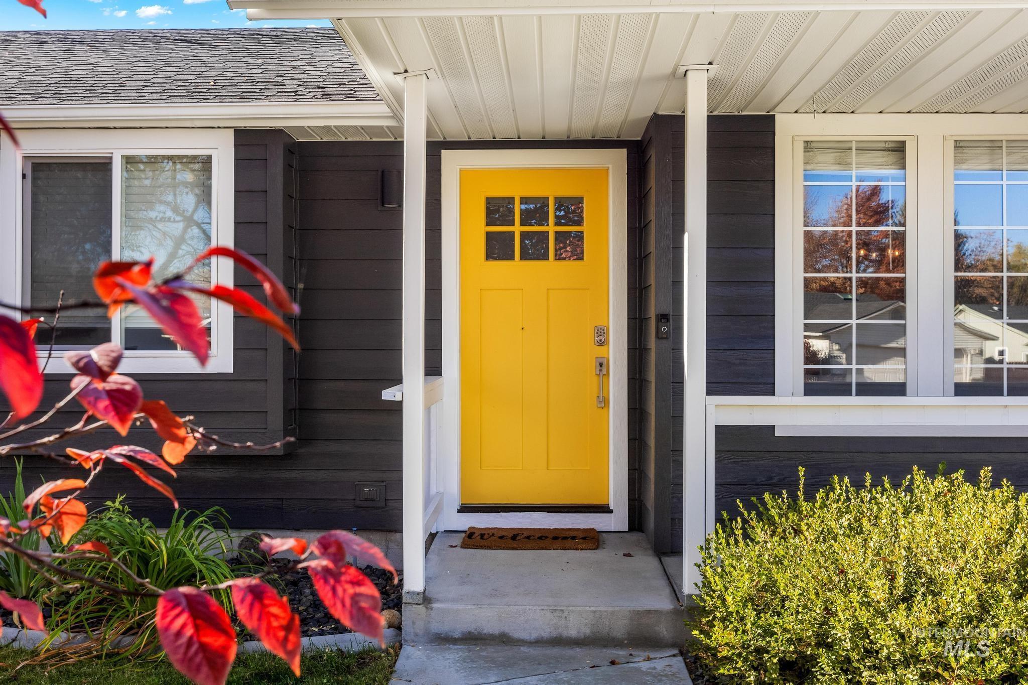 View of exterior entry featuring a shingled roof