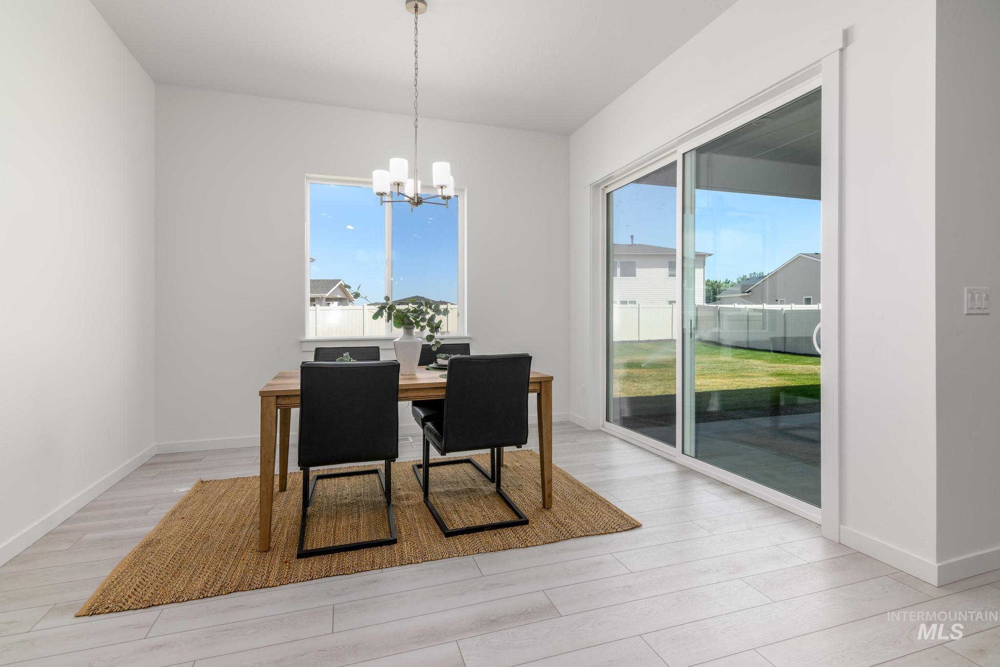 Dining space with a chandelier and light wood-style floors