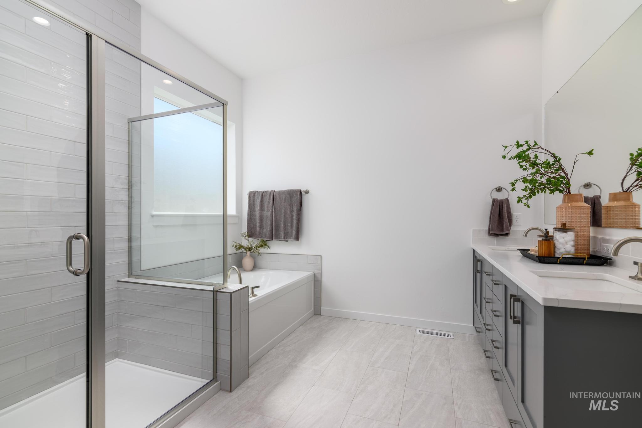 Bathroom with vanity, a bath, and a shower stall