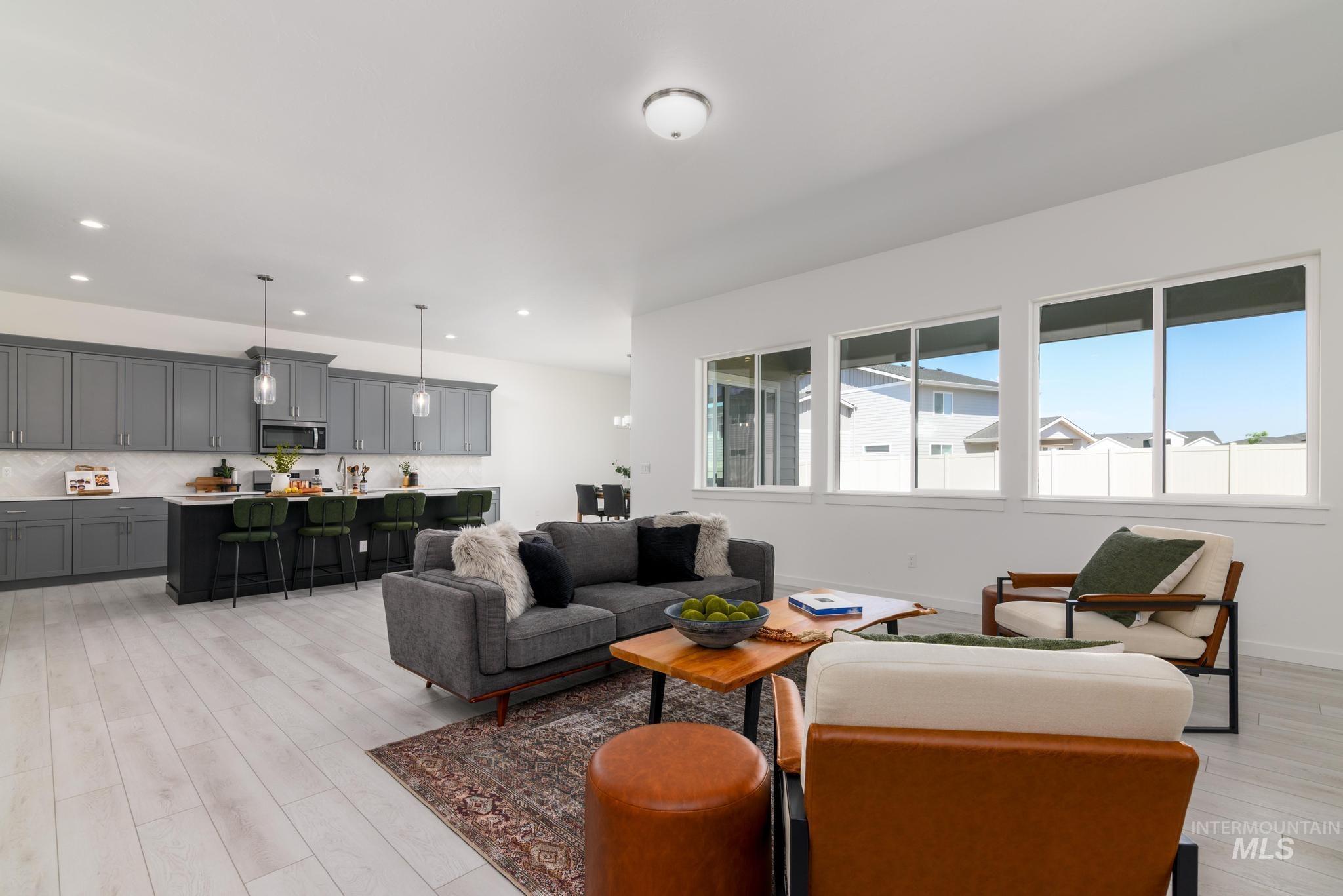 Living room featuring light wood-style flooring and recessed lighting
