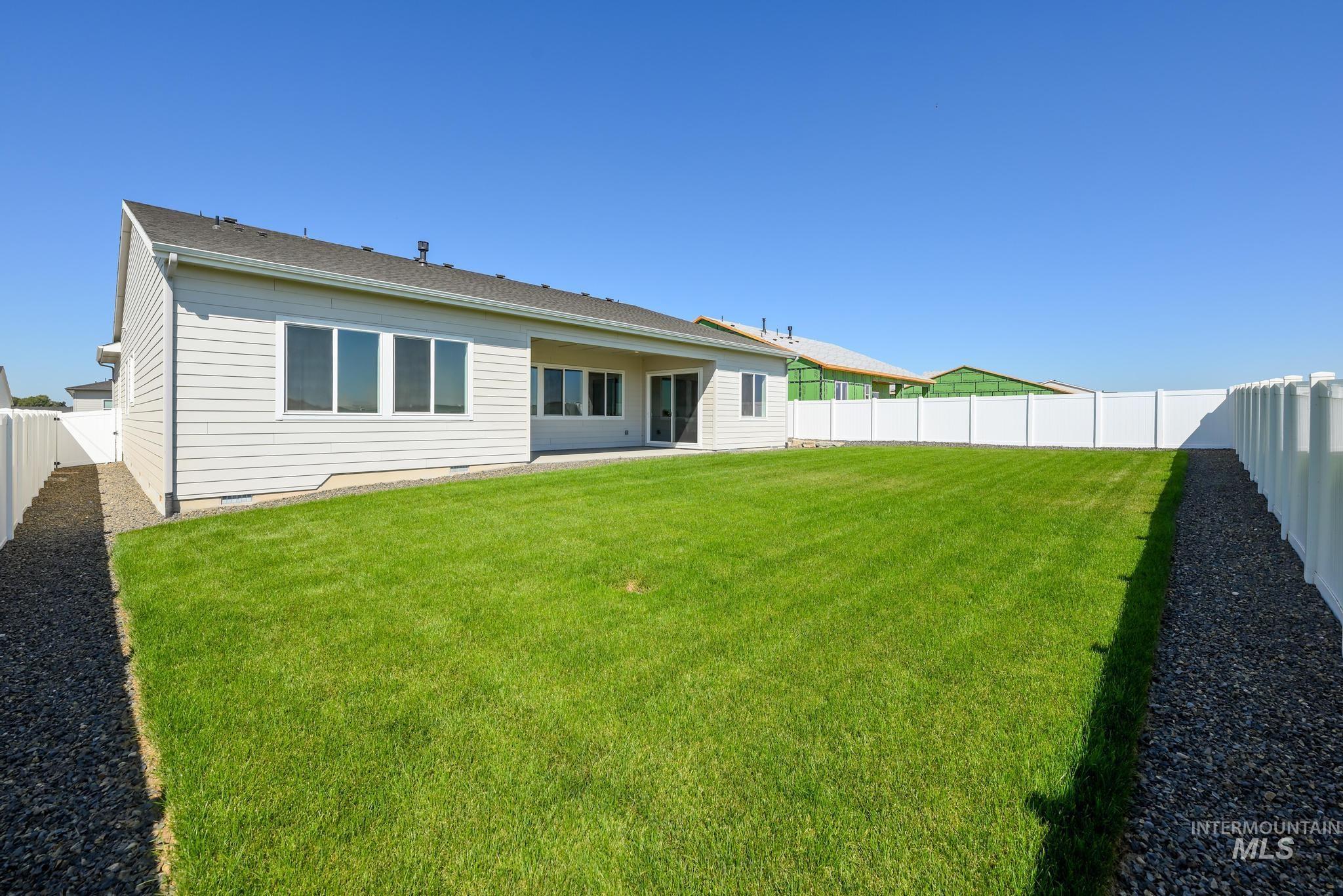 Rear view of property featuring a fenced backyard, a patio area, and crawl space