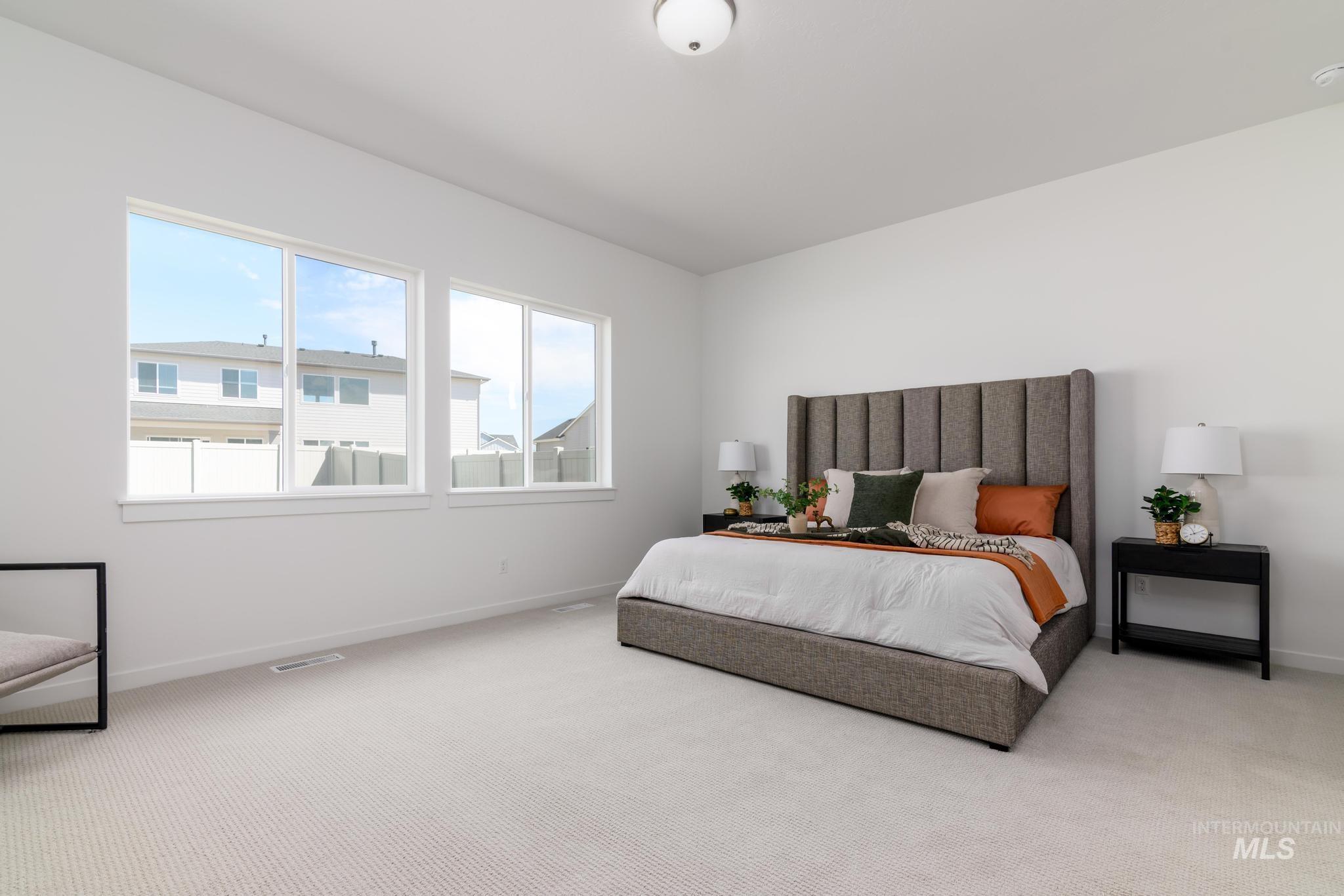 Carpeted bedroom with baseboards
