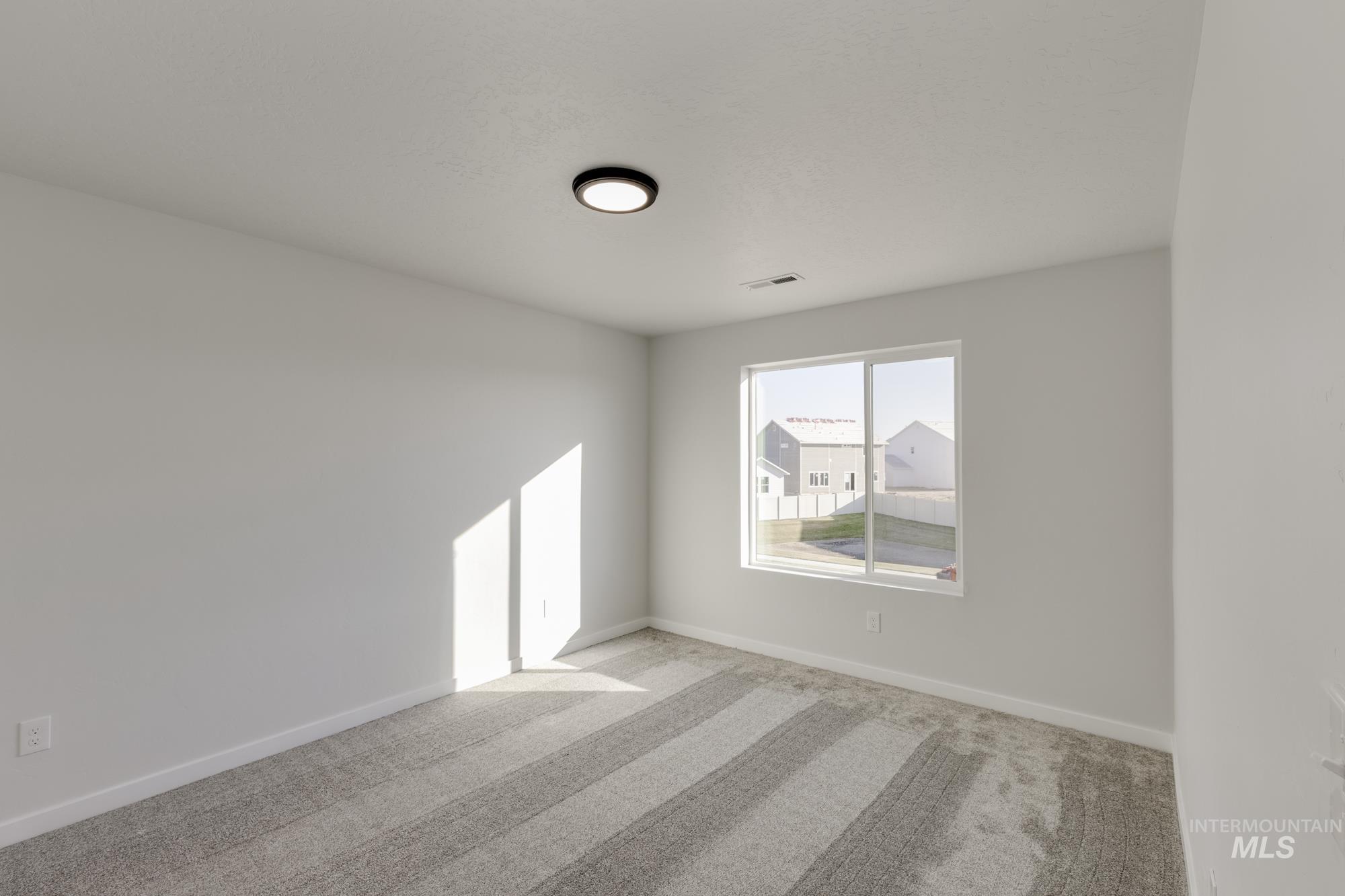 Spare room featuring carpet