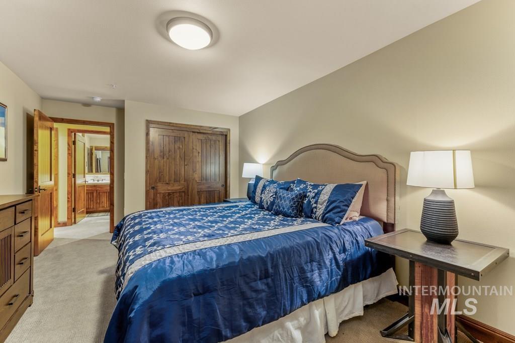 Carpeted bedroom with a closet and baseboards