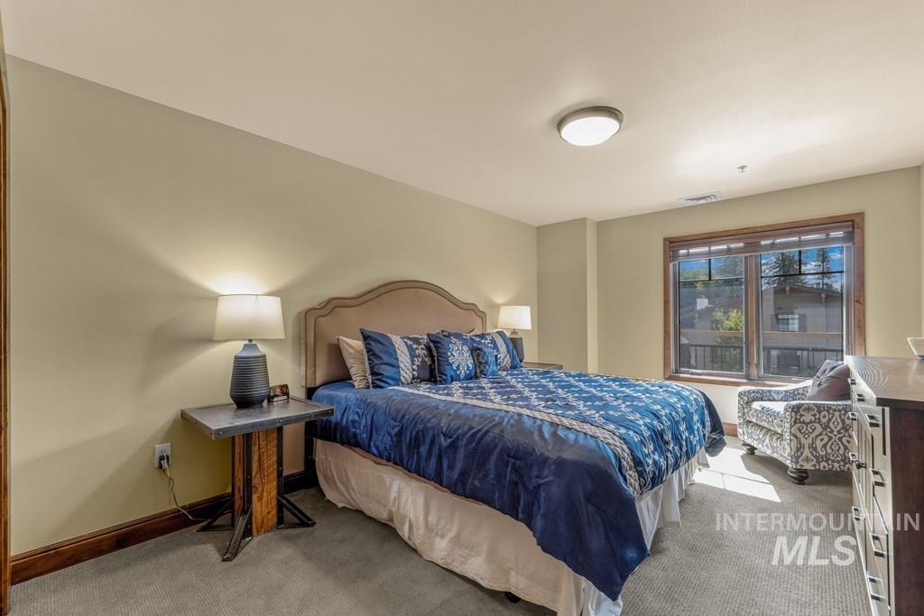 Bedroom featuring light carpet