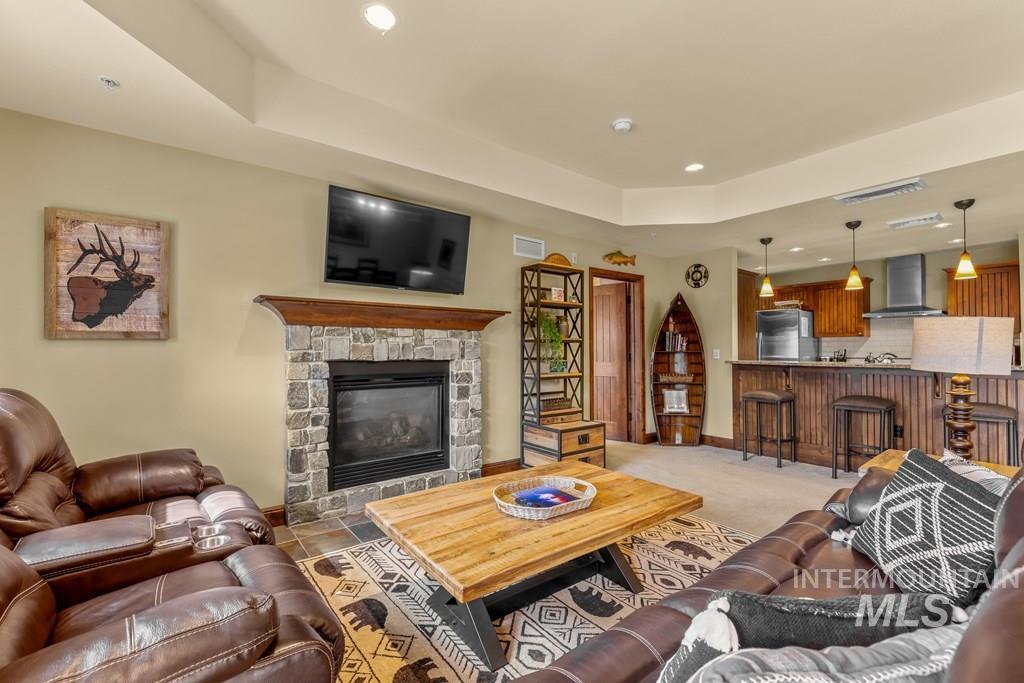 The great room has a stone, propane fireplace. The rustic furniture is included making it easy to start enjoying your mountain living.