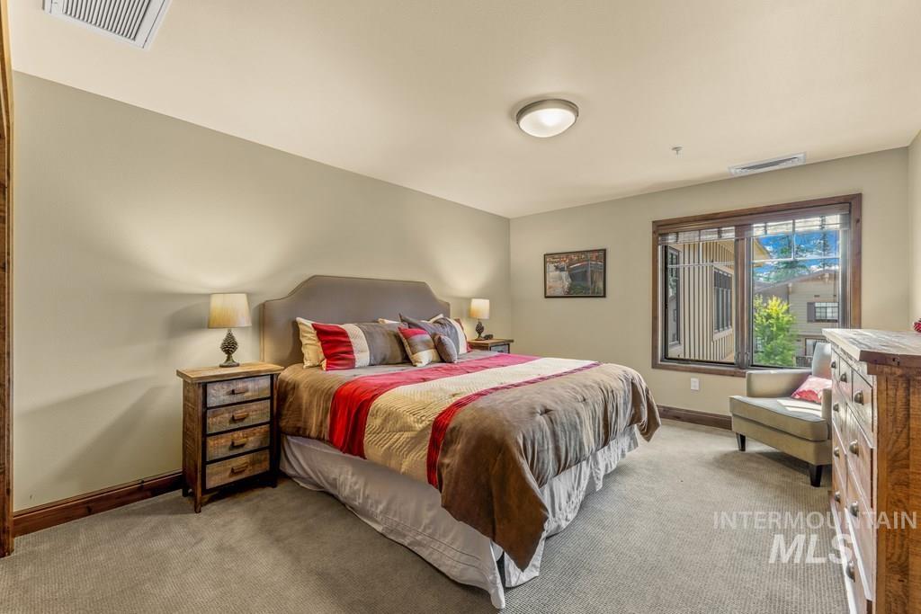 Bedroom featuring carpet and baseboards