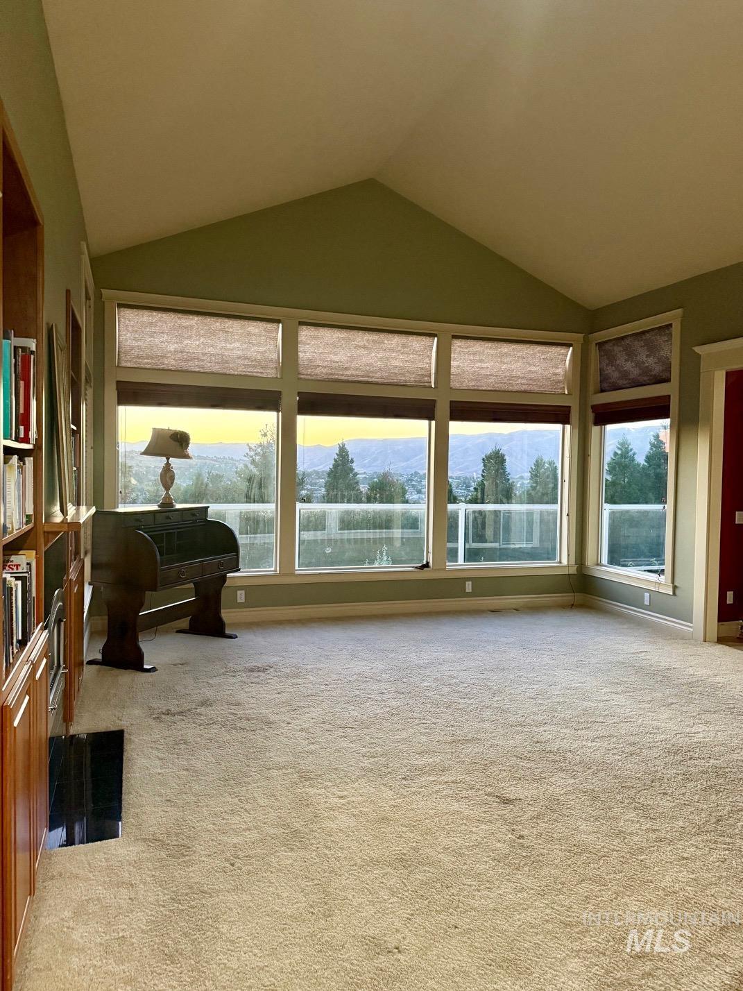 Living area with light colored carpet and a mountain view