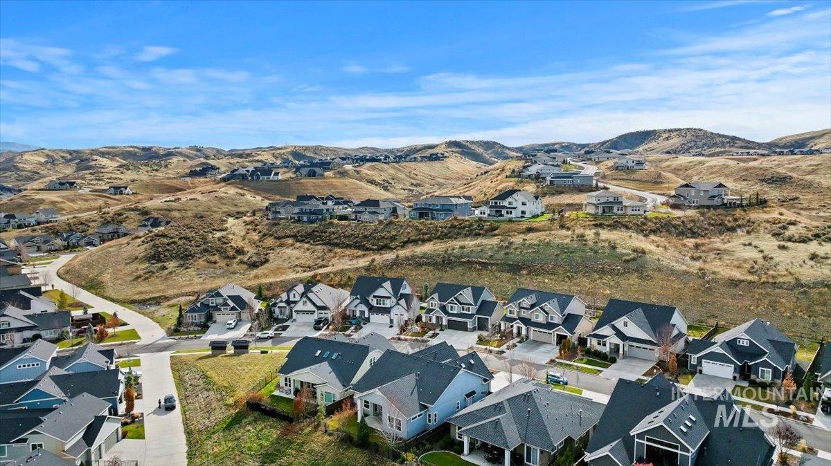 Aerial view of property's location with nearby suburban area and a mountain backdrop