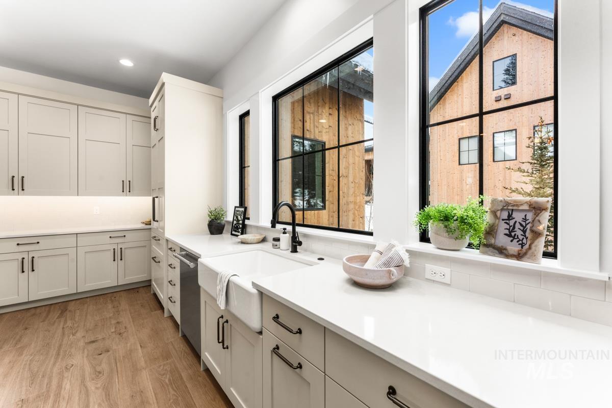 Kitchen featuring light wood finished floors and dishwasher