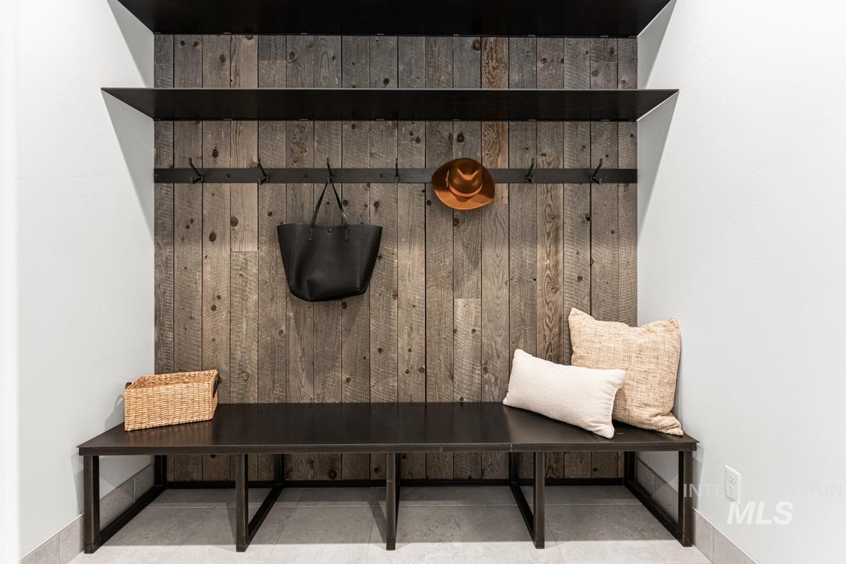 Mudroom with wood walls and baseboards