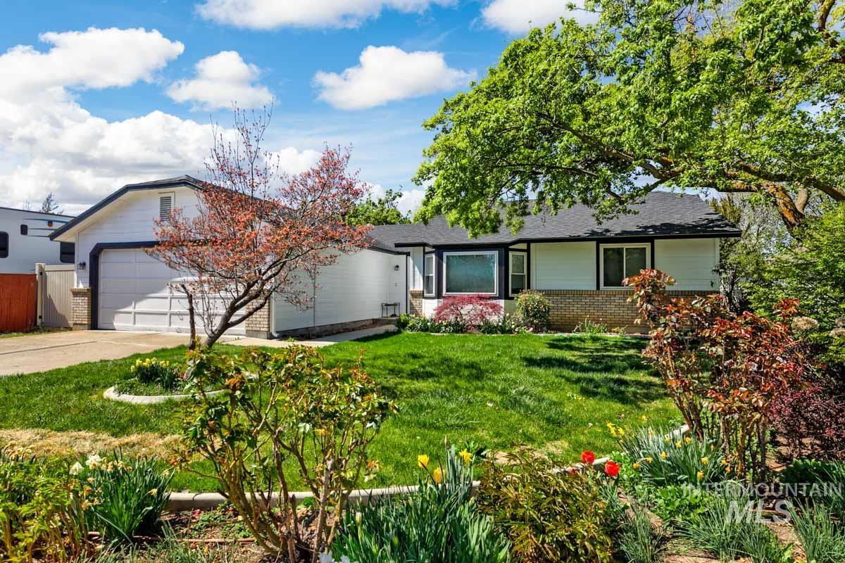 Ranch-style house with brick siding, concrete driveway, an attached garage, and a shingled roof