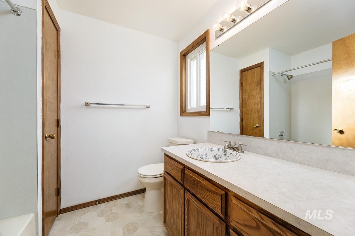 Bathroom with vanity and light flooring