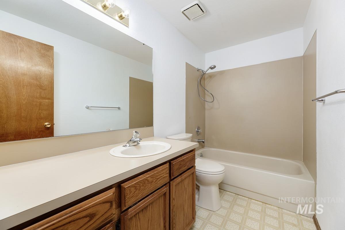 Full bathroom with vanity, tub / shower combination, and light flooring