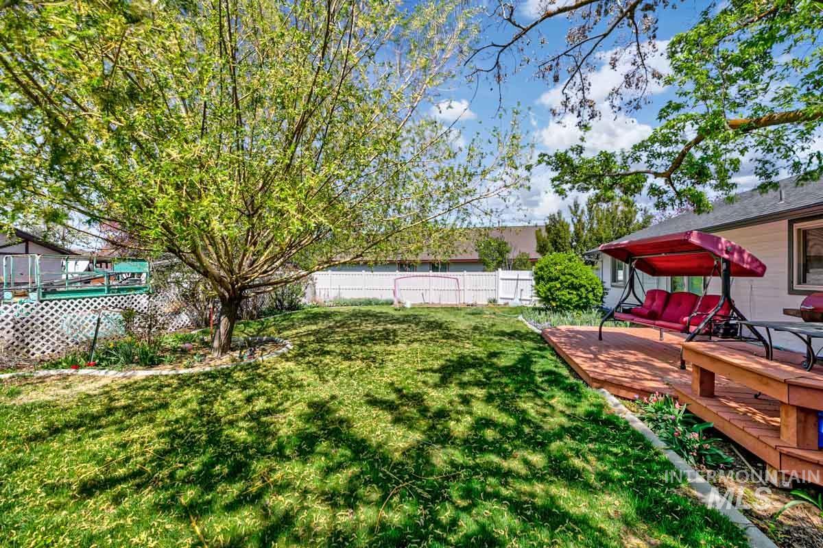 Fenced backyard featuring a wooden deck