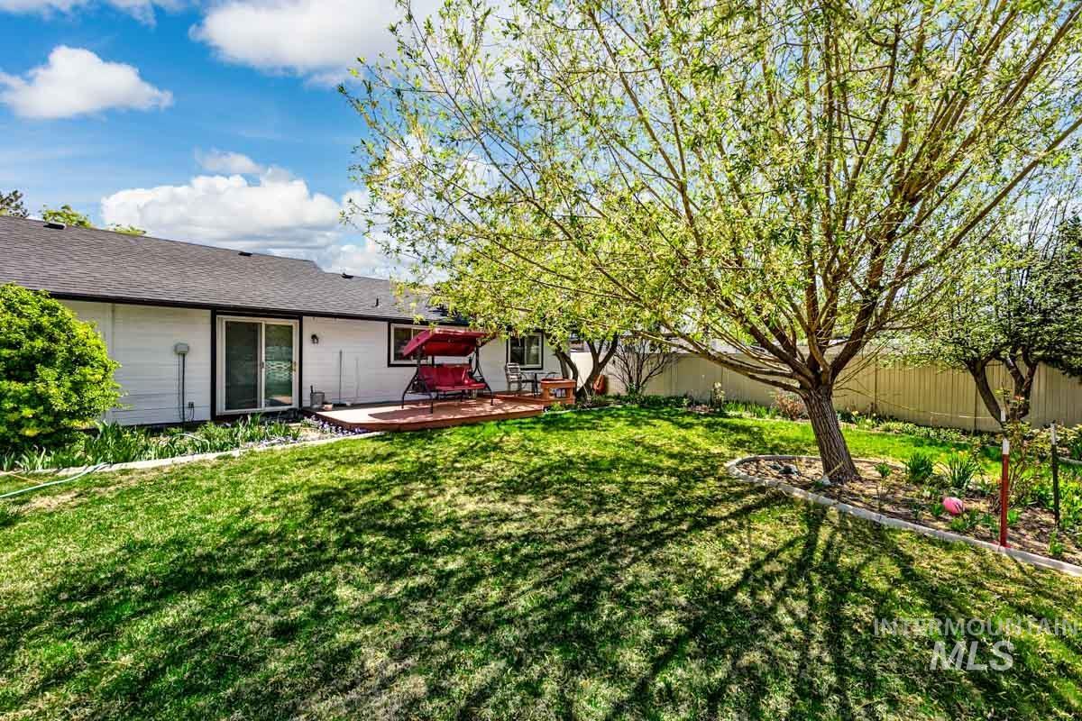 Fenced backyard featuring a deck