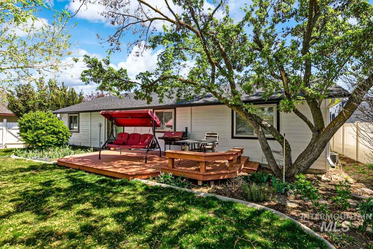 Rear view of property featuring a wooden deck