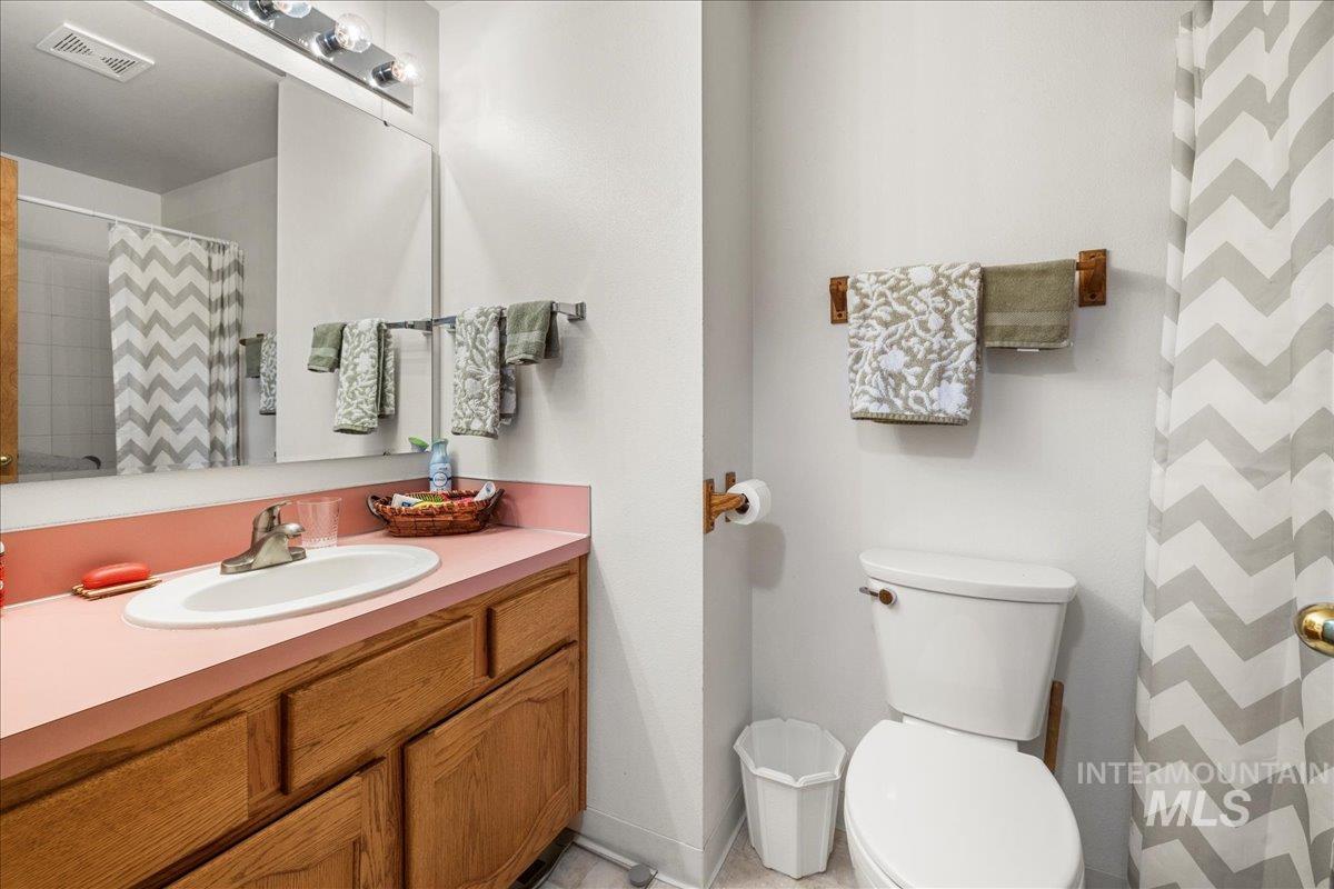 Full bathroom featuring vanity and a shower with curtain