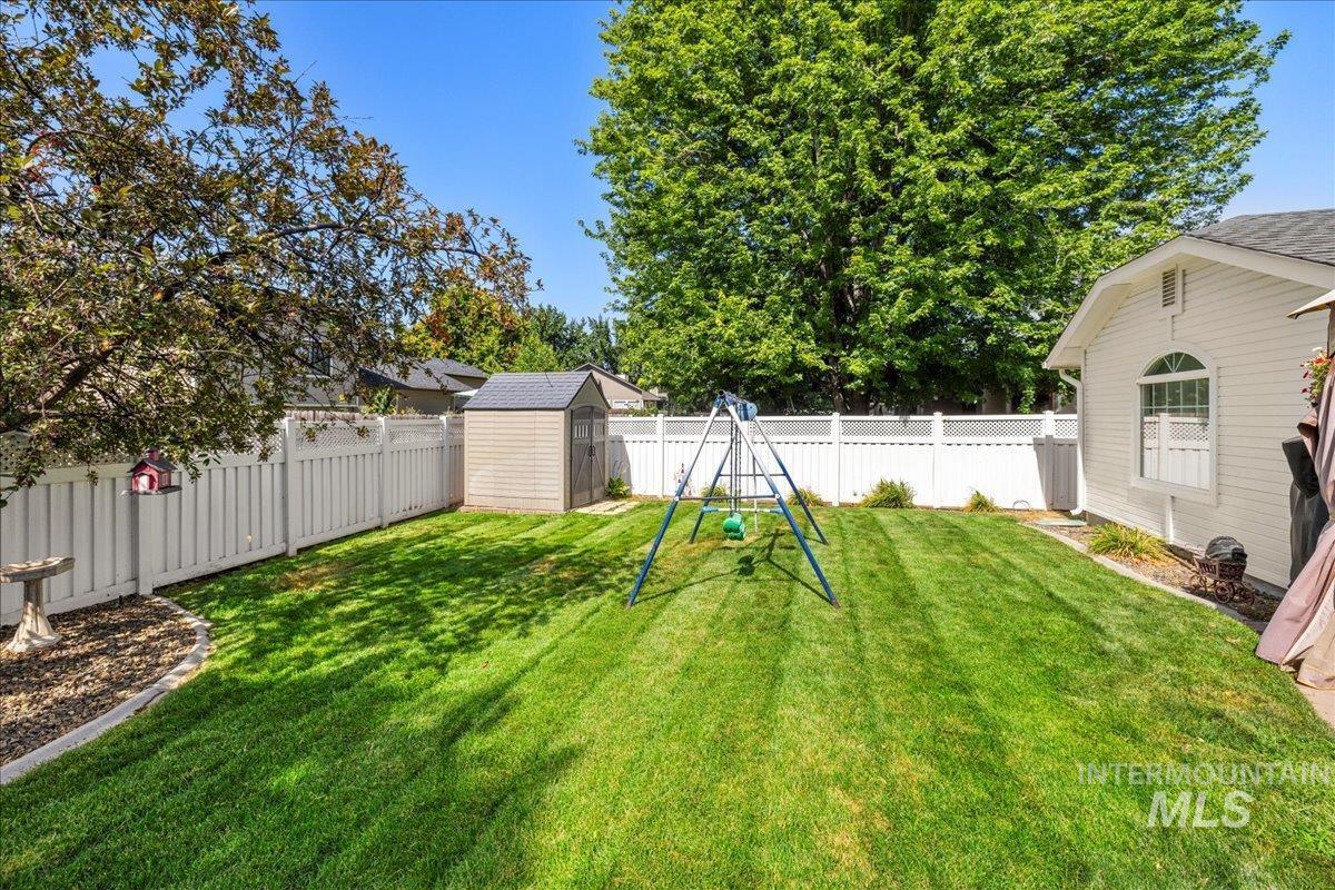 Fenced backyard with a storage unit
