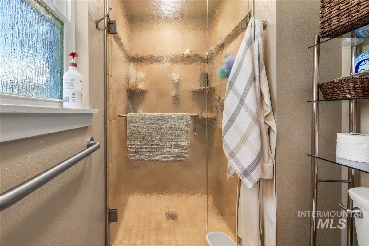 Bathroom with a stall shower and toilet