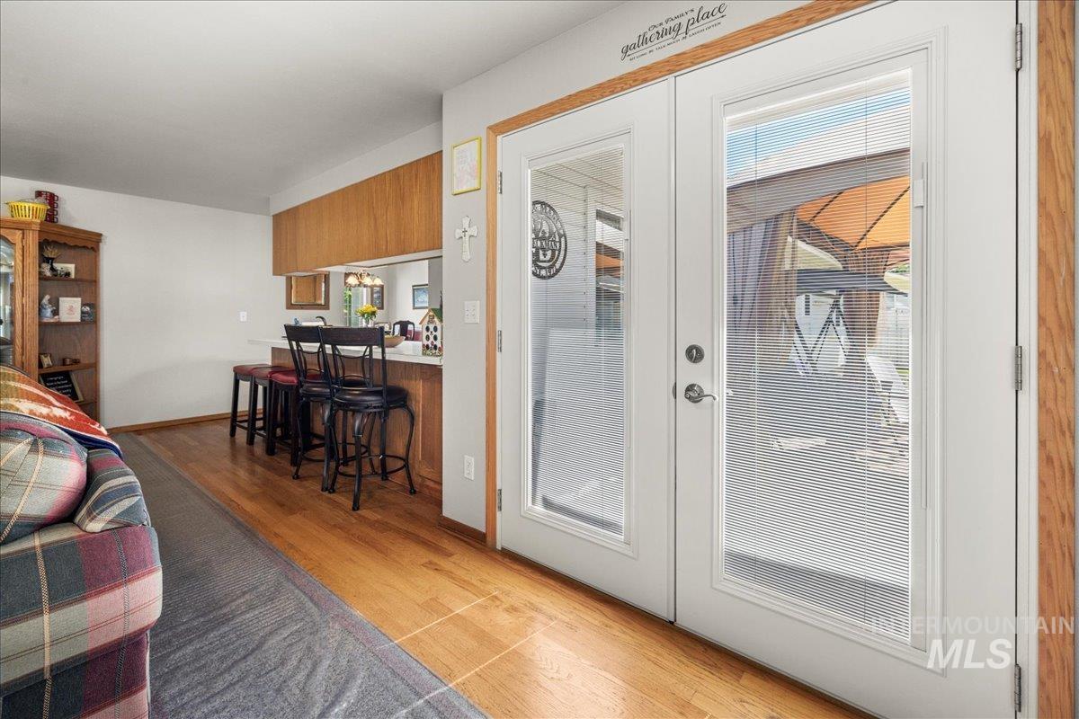 Doorway to outside featuring light wood-style flooring and french doors