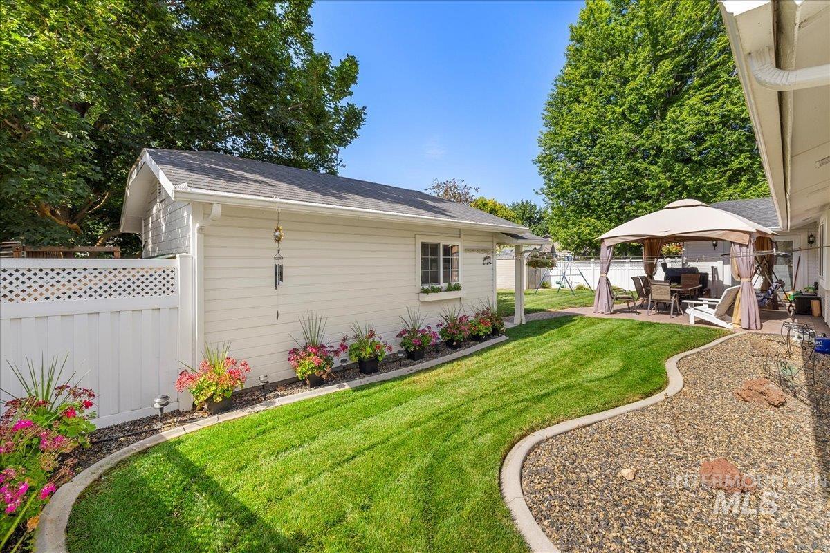 Fenced backyard with a gazebo and a patio