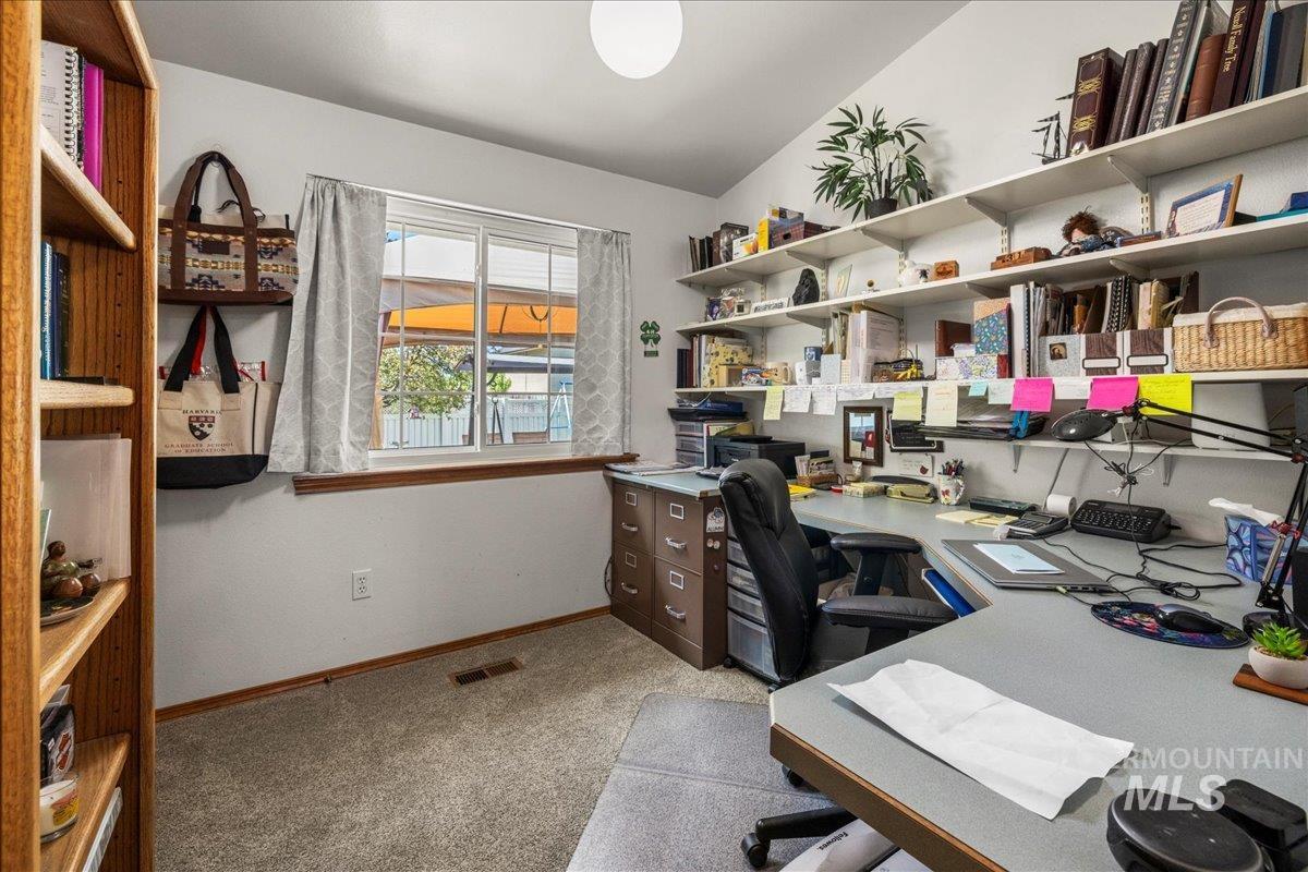 Carpeted office featuring baseboards