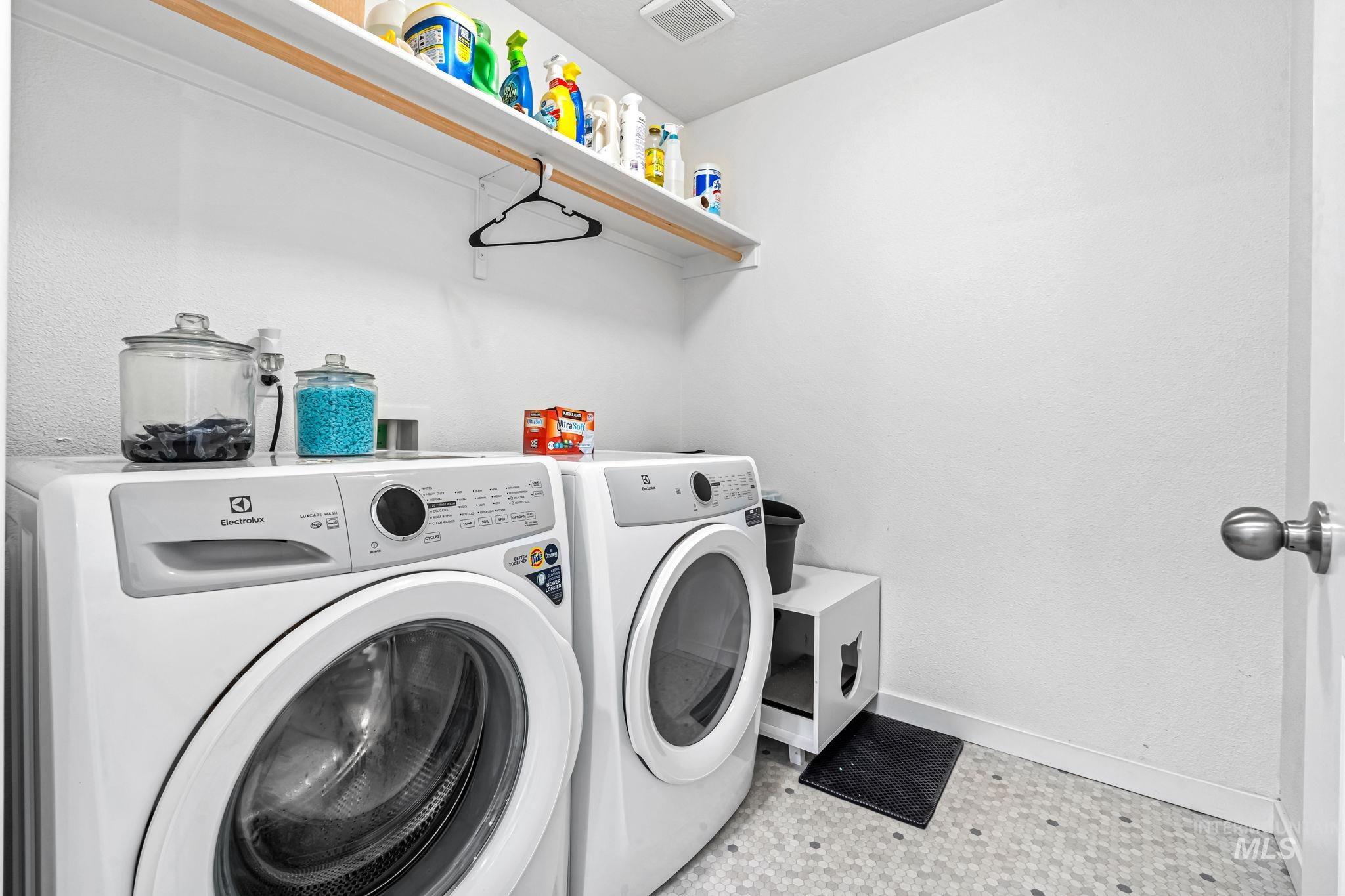Laundry area featuring independent washer and dryer and light flooring