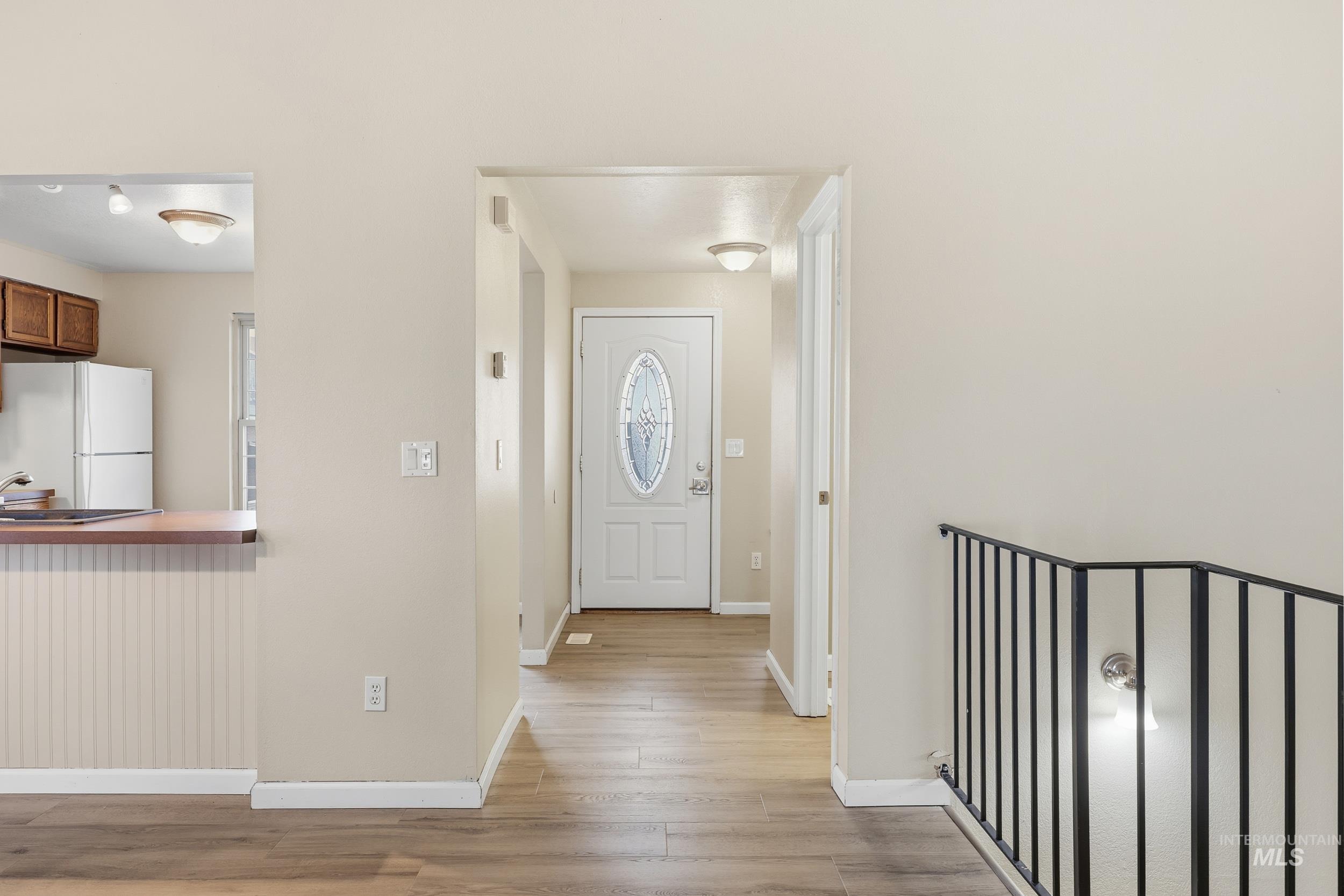 Entryway featuring baseboards and light wood-style floors