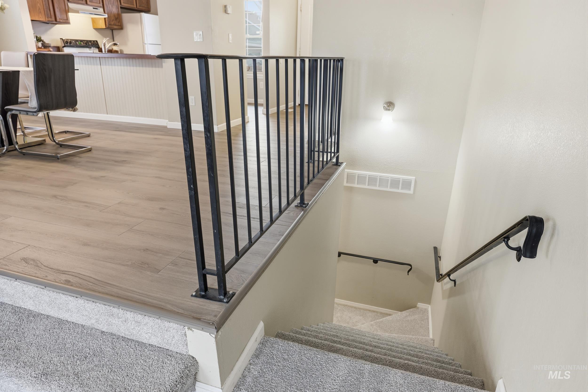 Staircase featuring baseboards and carpet flooring