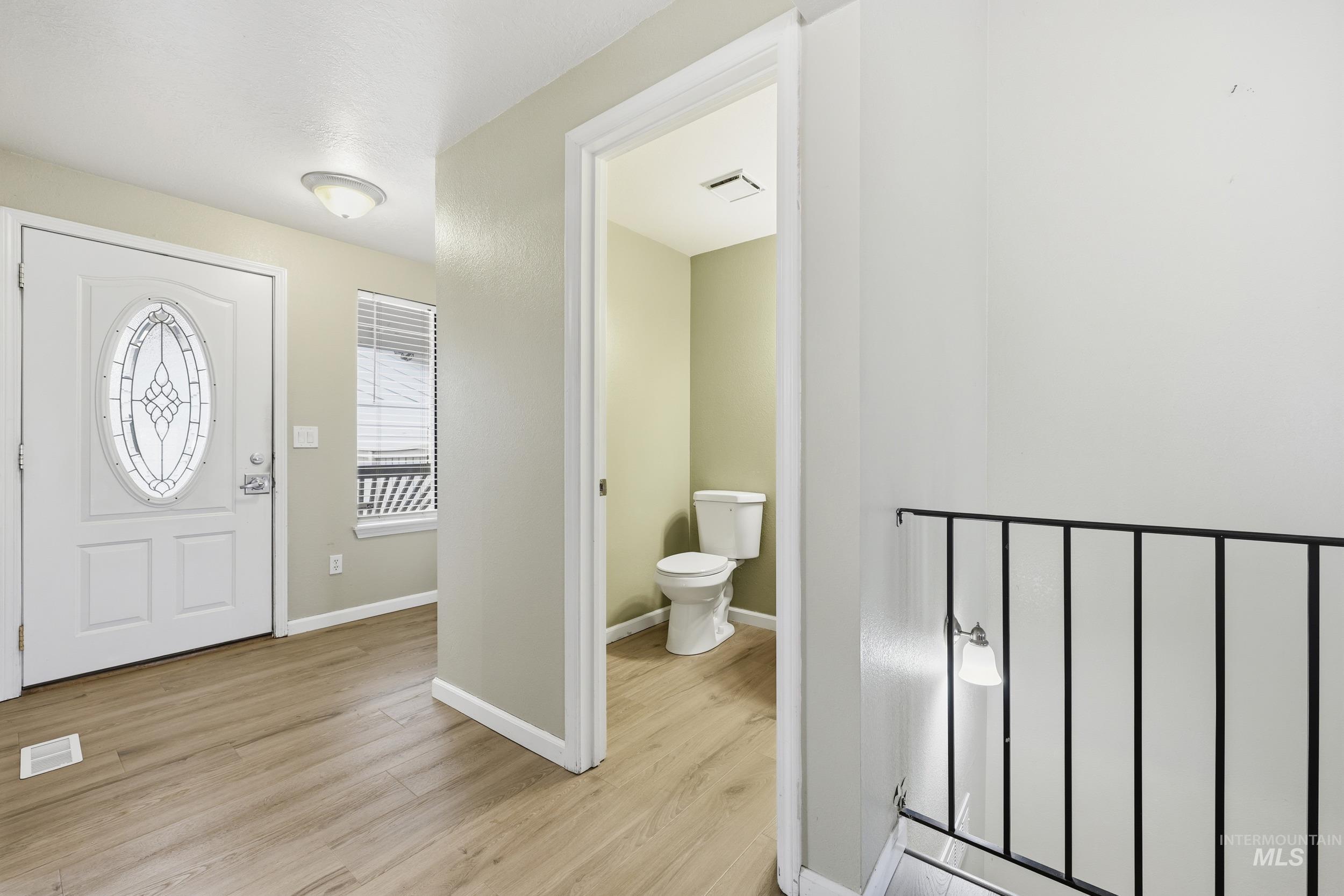 Foyer featuring baseboards and light wood-style flooring