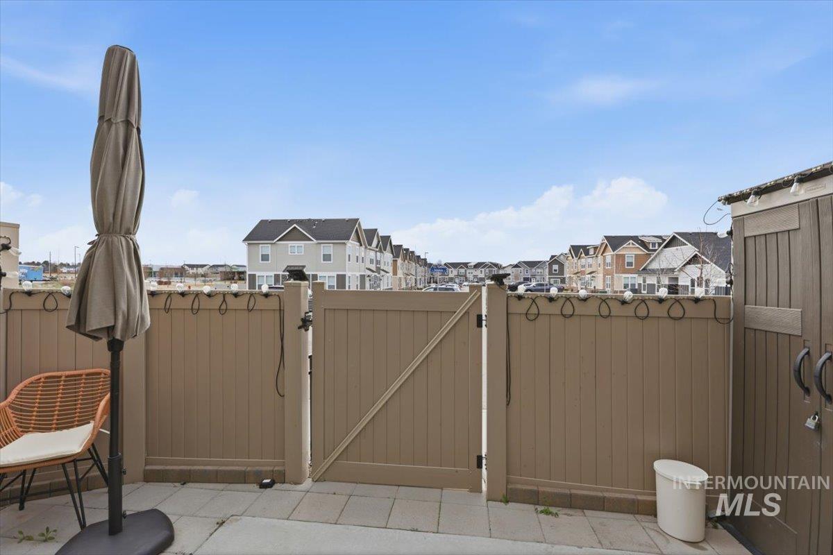 View of patio / terrace with a gate and a residential view