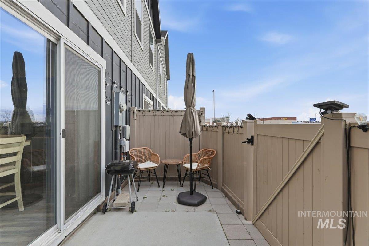 View of patio featuring a gate