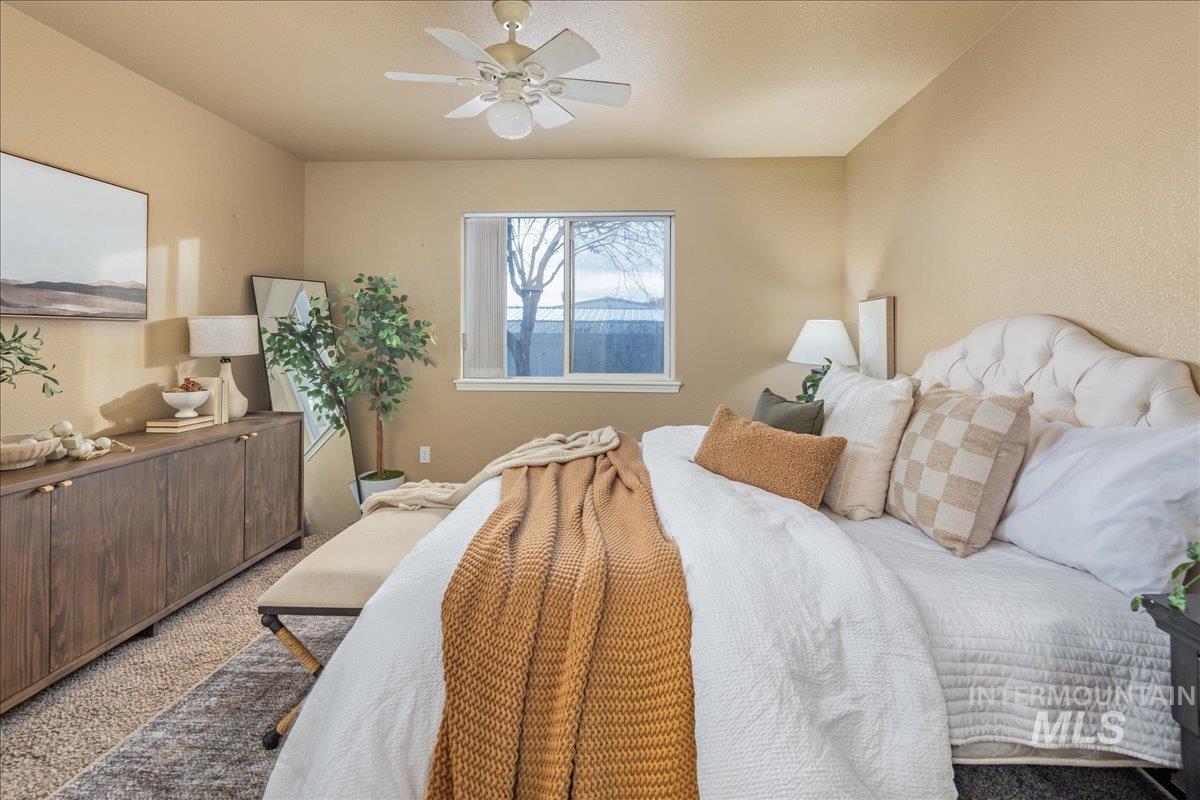 Bedroom with a ceiling fan and carpet flooring