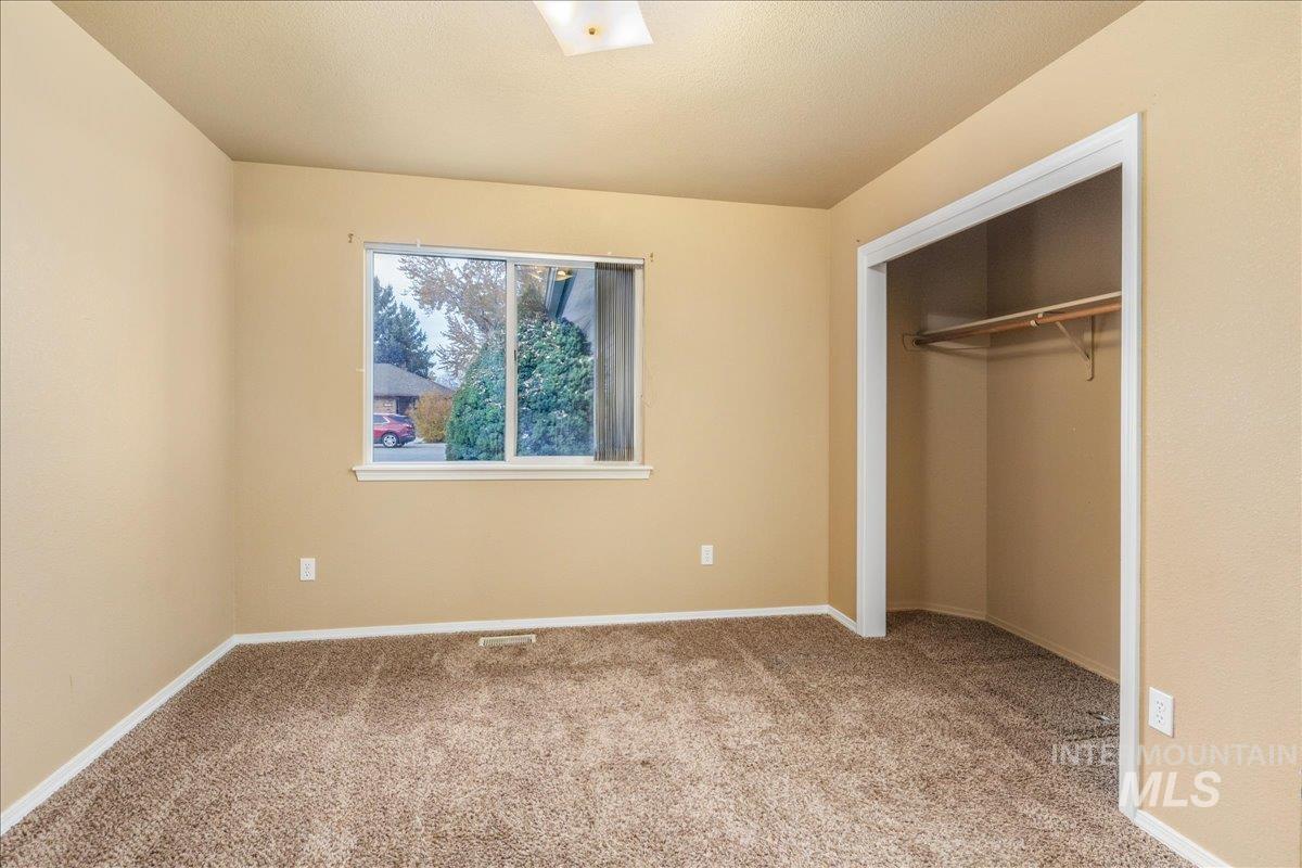 Unfurnished bedroom featuring carpet floors and a closet